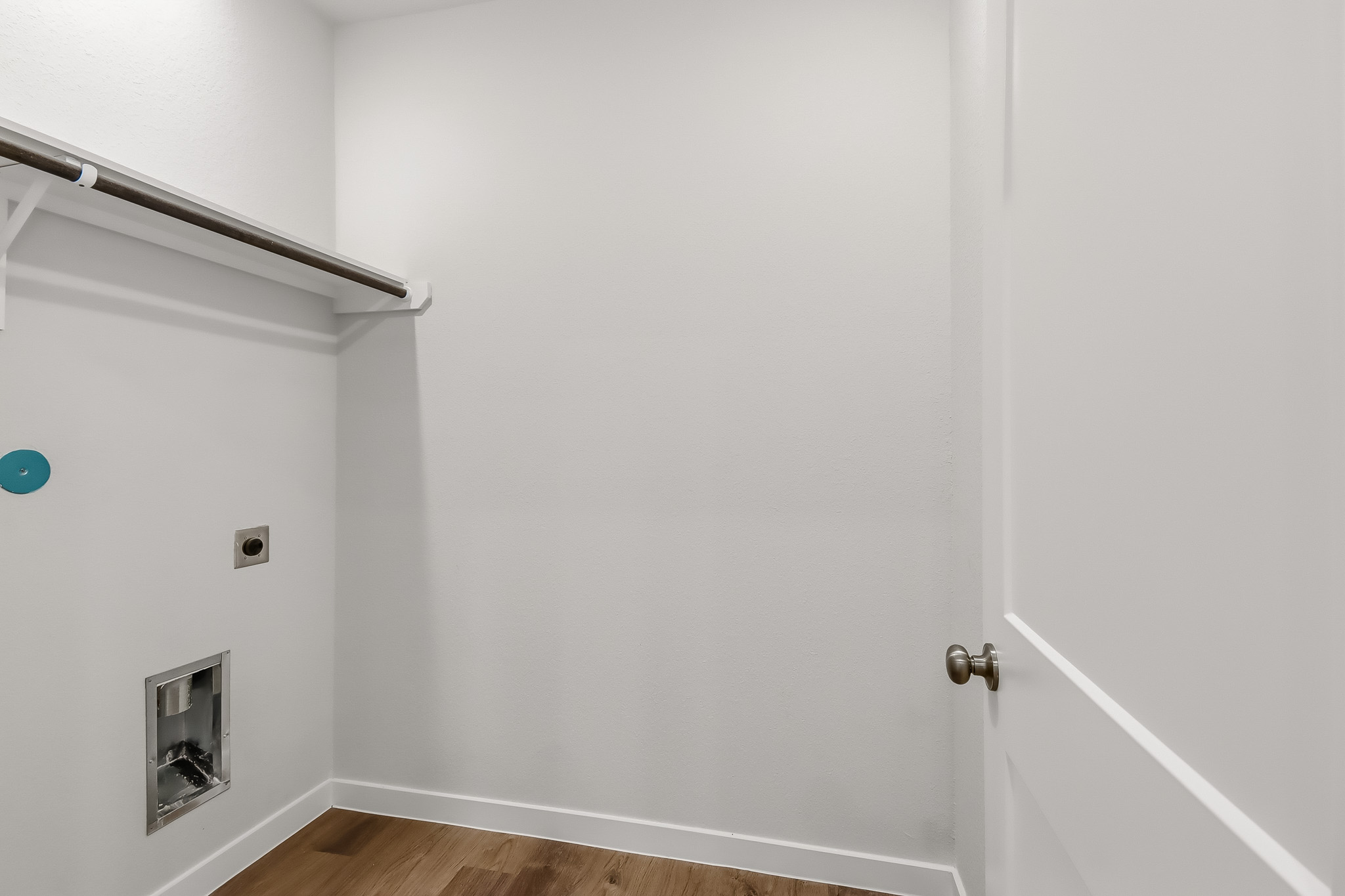 A white door with a metal bar.