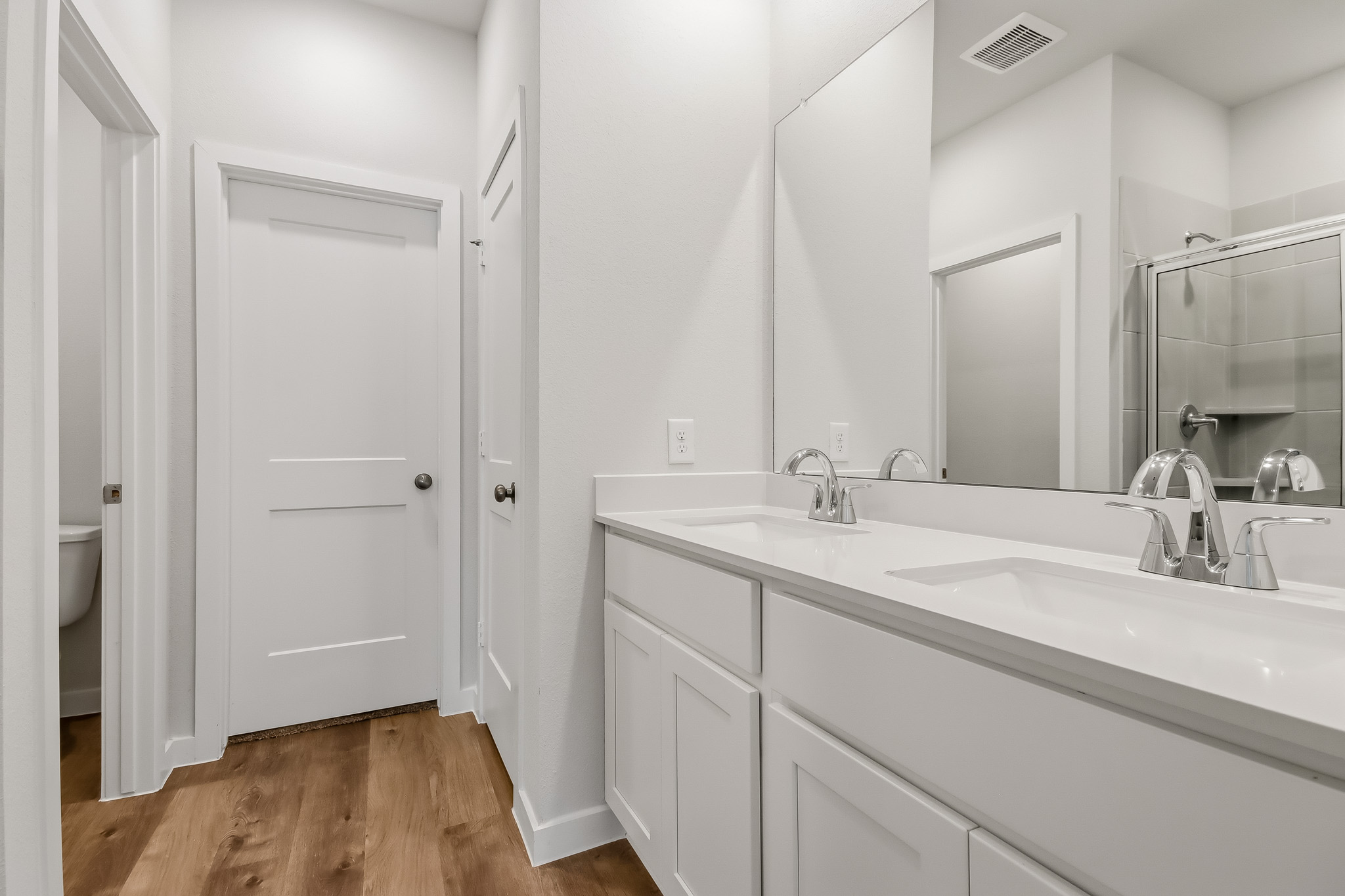 A bathroom with a large mirror.
