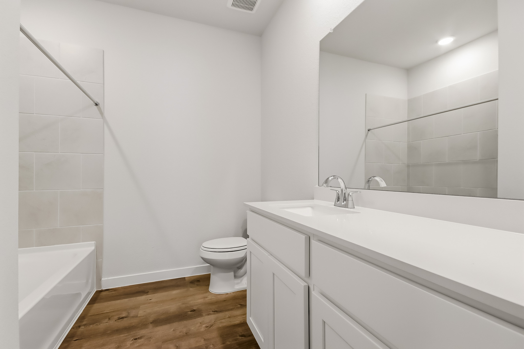 A bathroom with a tub toilet and sink.