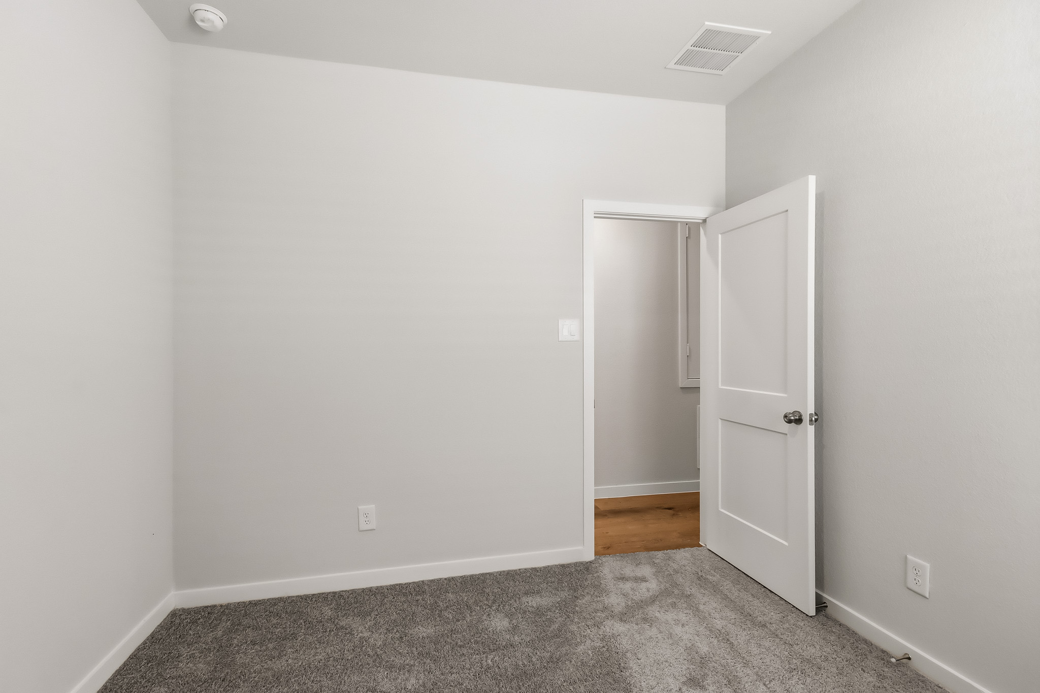 A room with a door and a window.