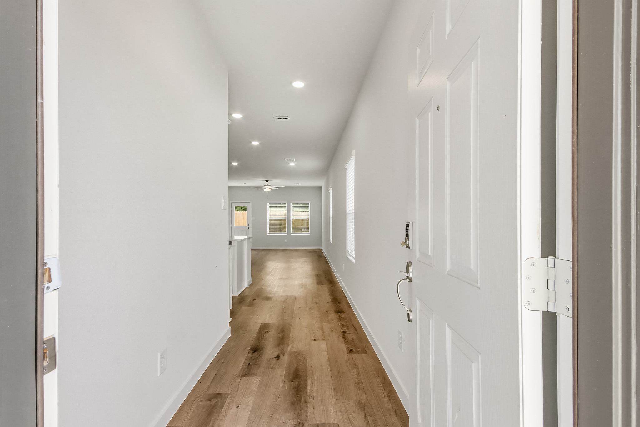 A hallway with white doors.