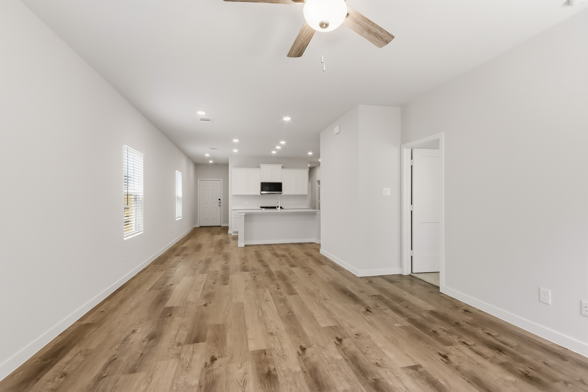 A room with white walls and a wood floor.