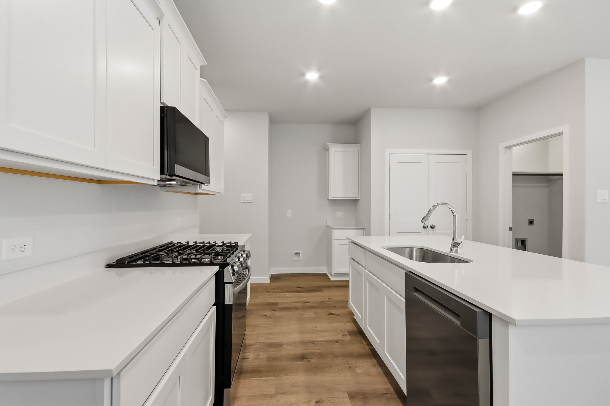A kitchen with white cabinets.
