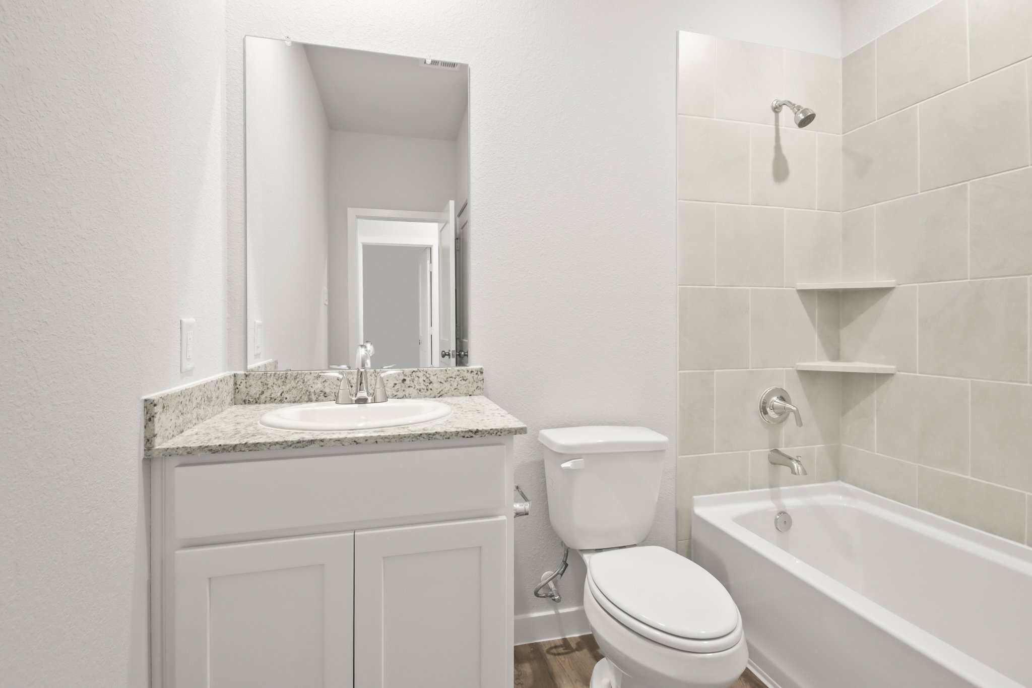 A bathroom with a sink toilet and bathtub.