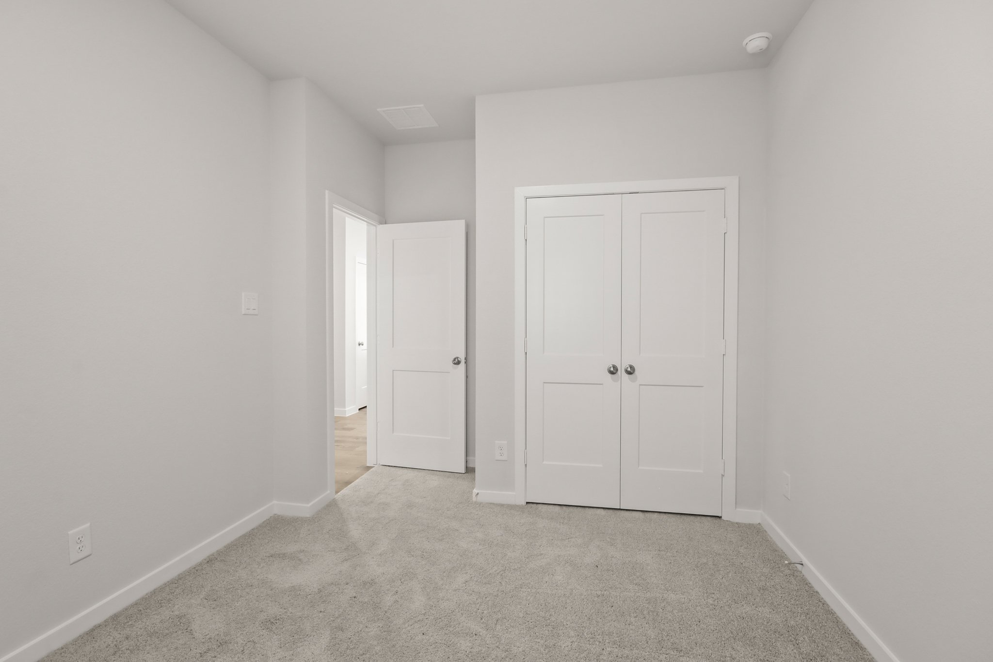 A hallway with white doors.