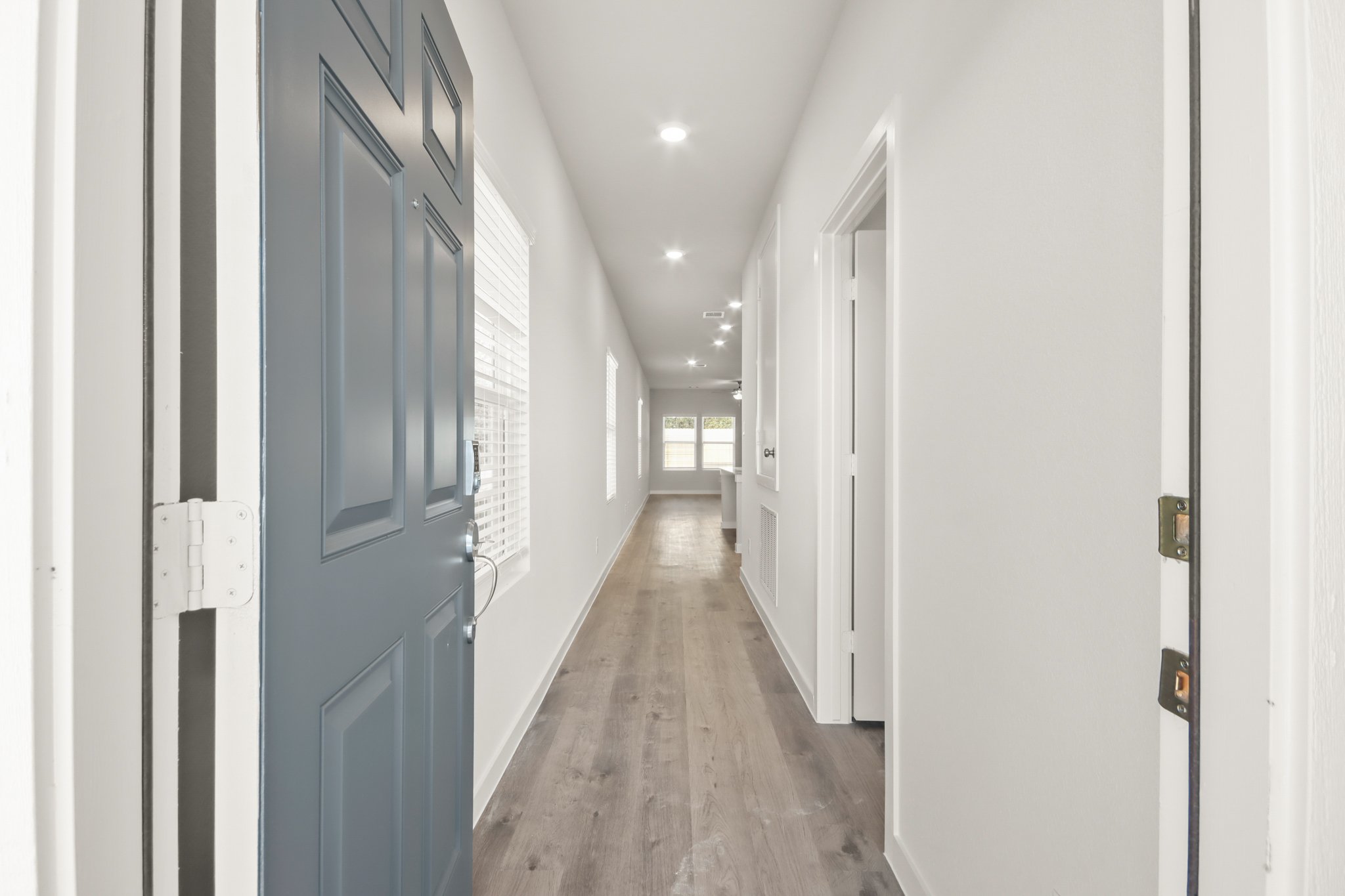 A hallway with blue doors.
