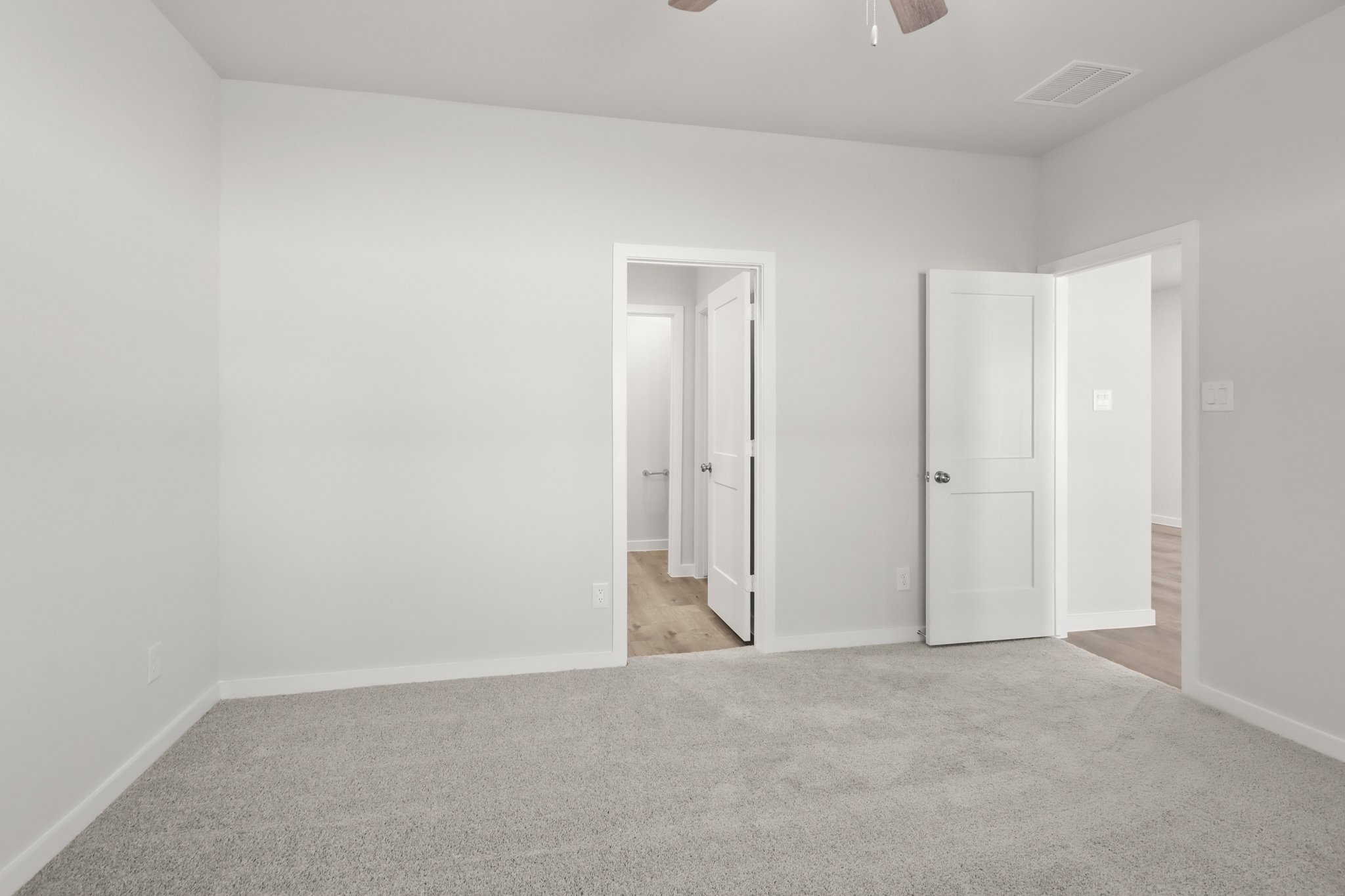 A hallway with white doors.