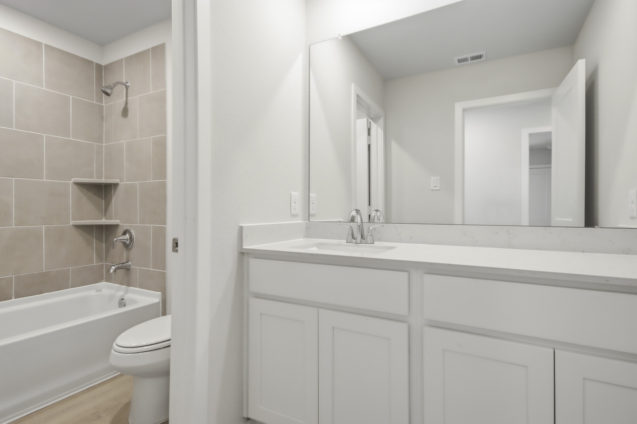 A bathroom with a sink toilet and bathtub.