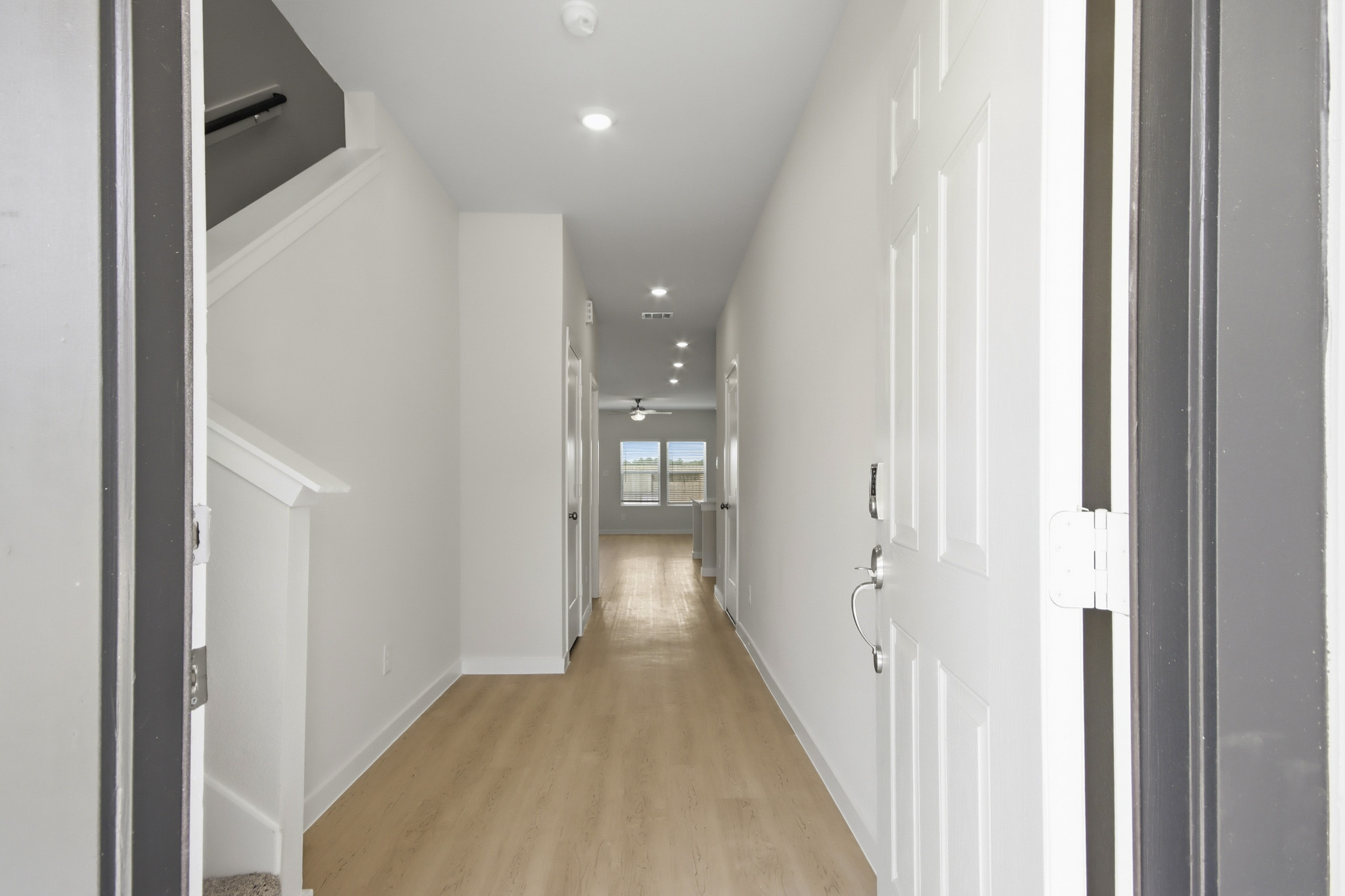 A hallway with white doors.