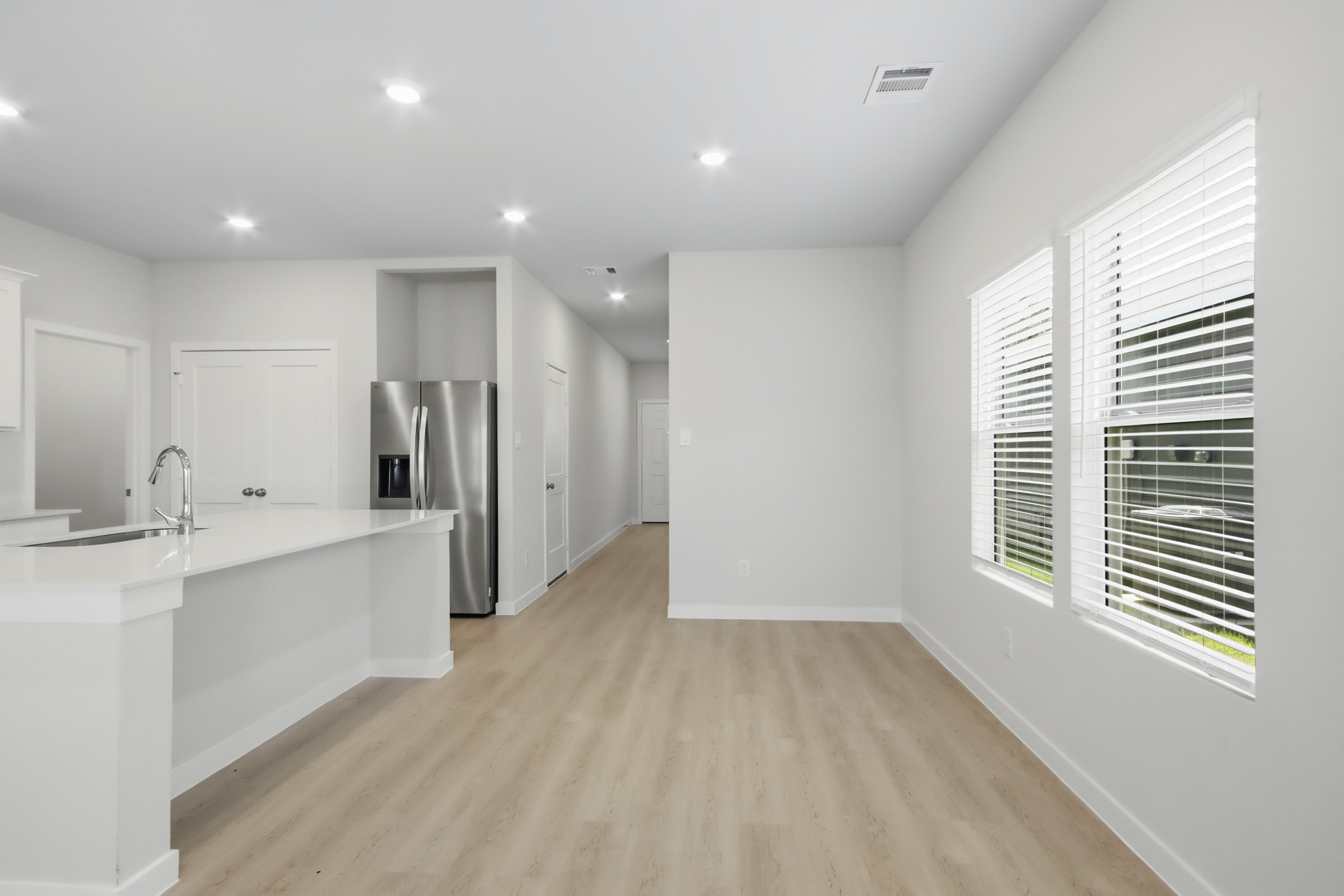 A large kitchen with white cabinets.