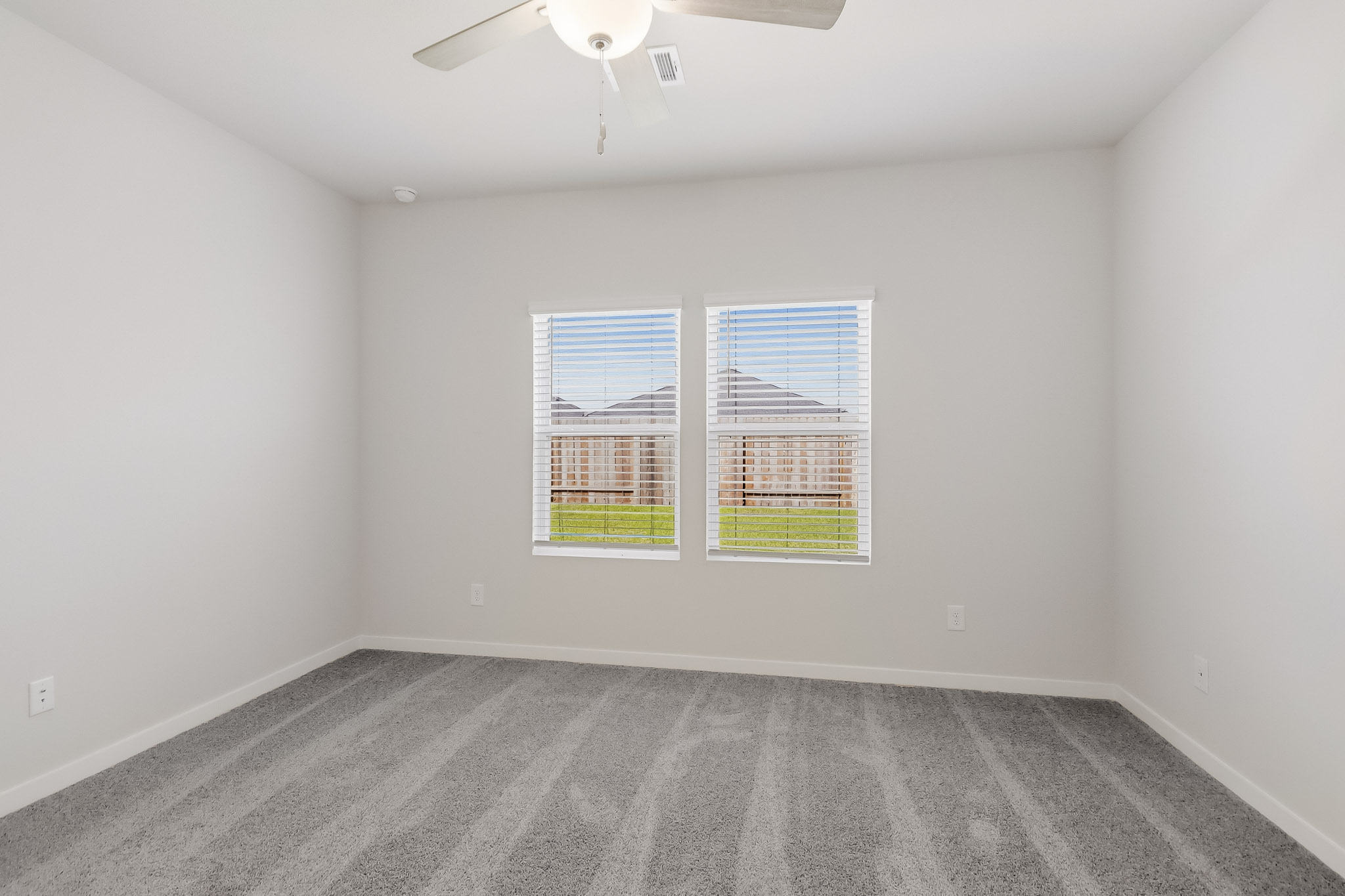 A room with a window and a carpet.