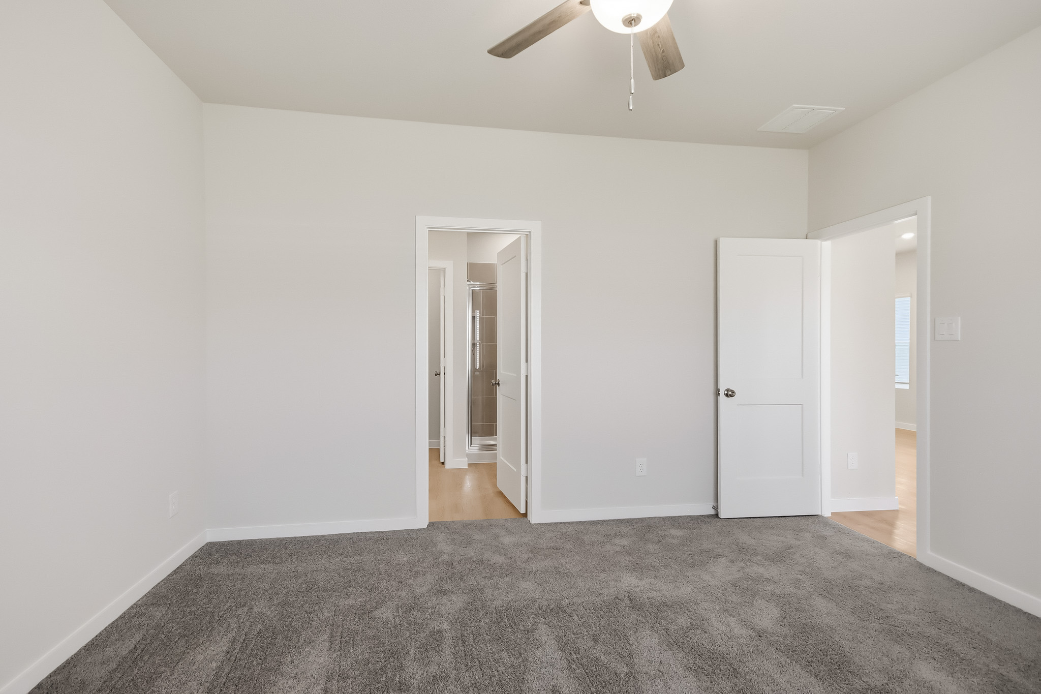 A room with white walls and a carpet.
