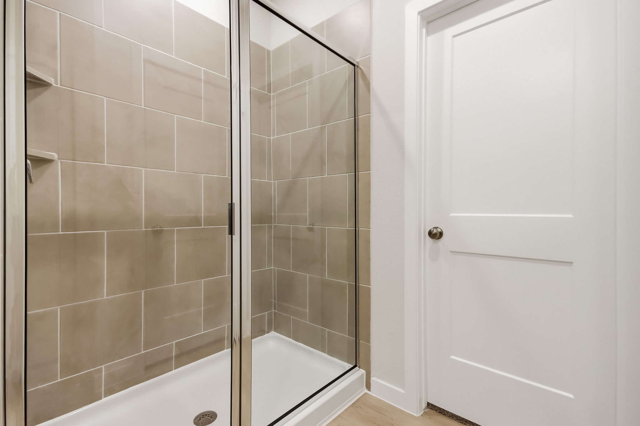 A shower with a glass door.