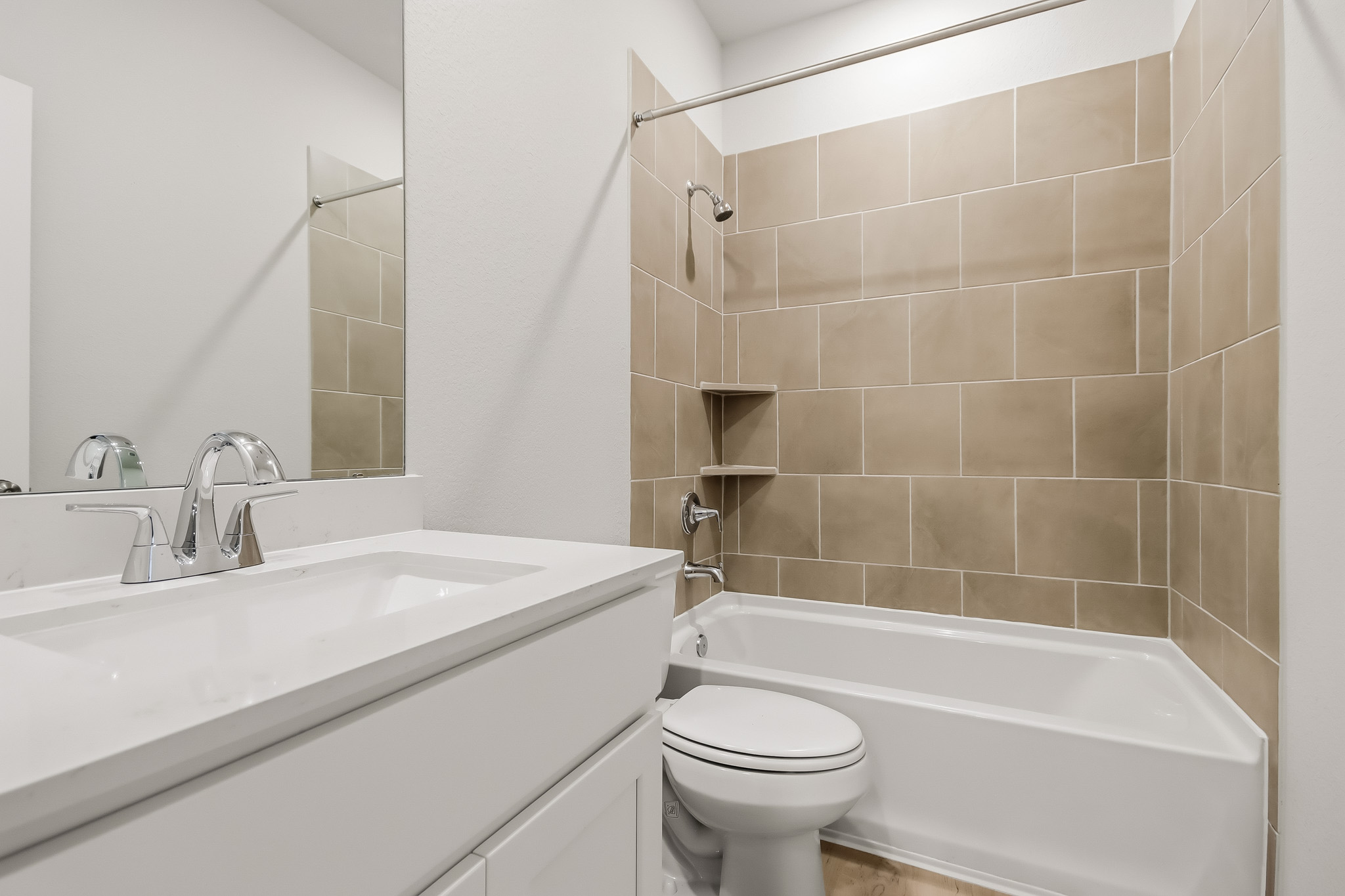 A bathroom with a tub toilet and sink.