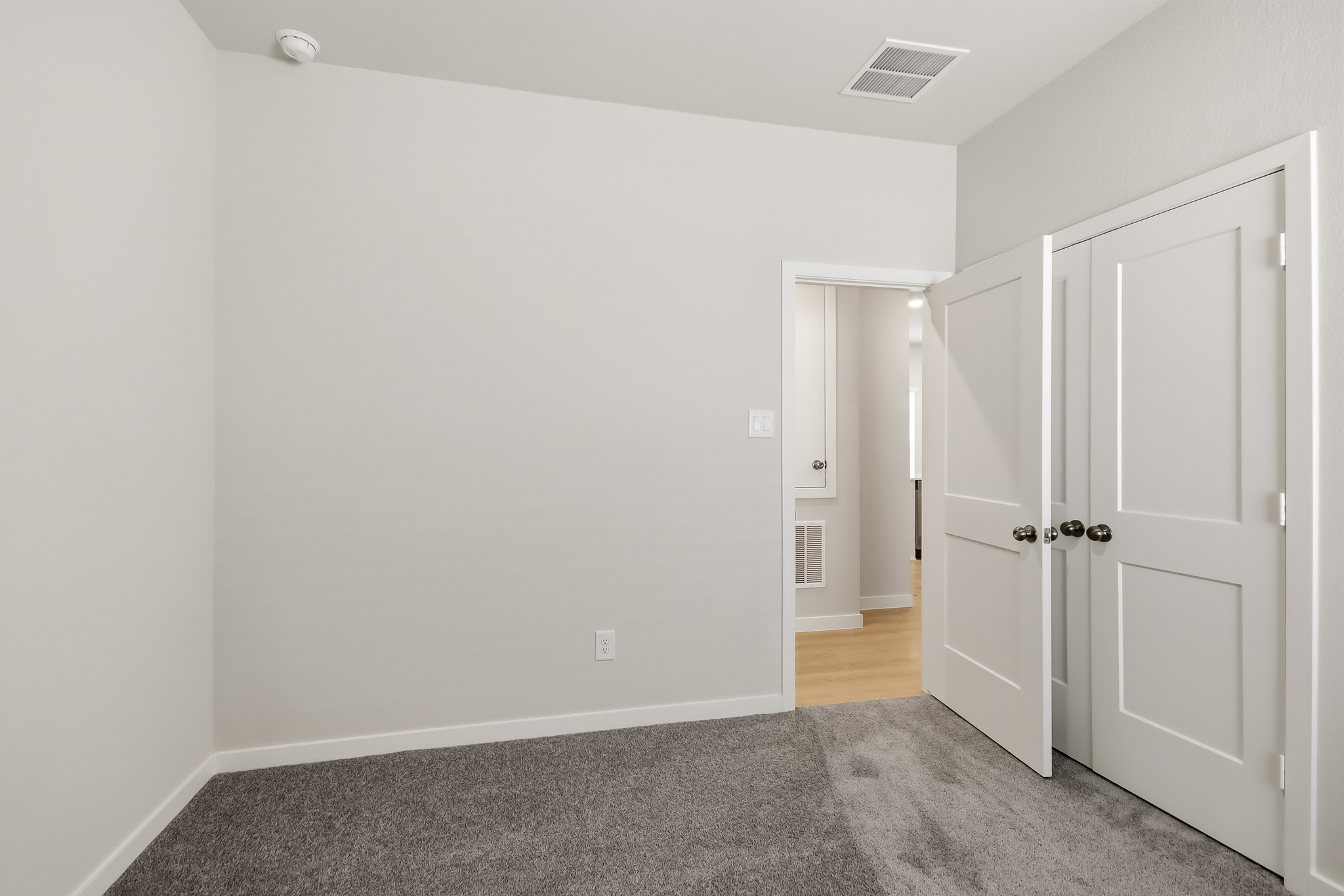 A hallway with white doors.