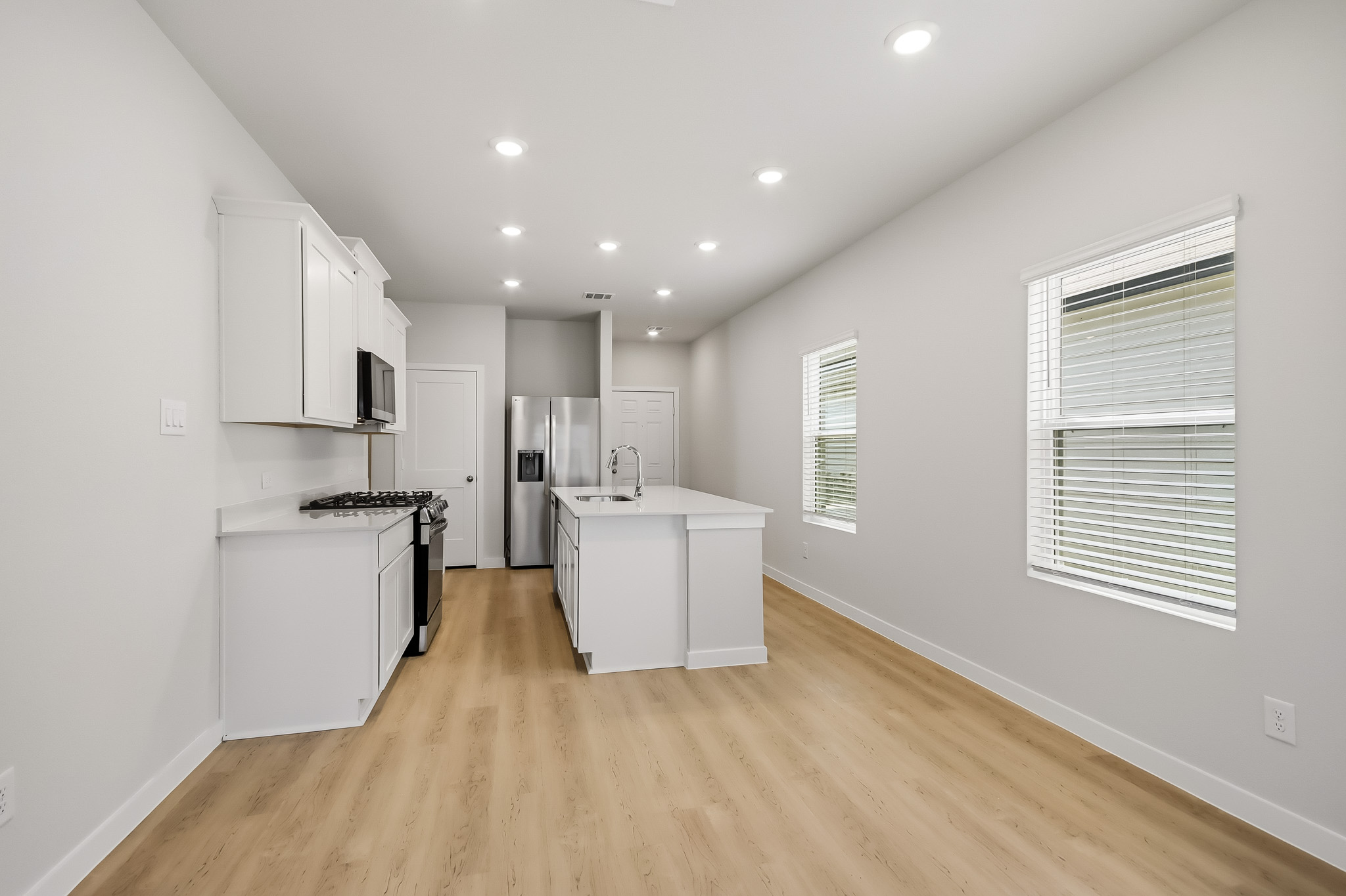 A kitchen with white cabinets.