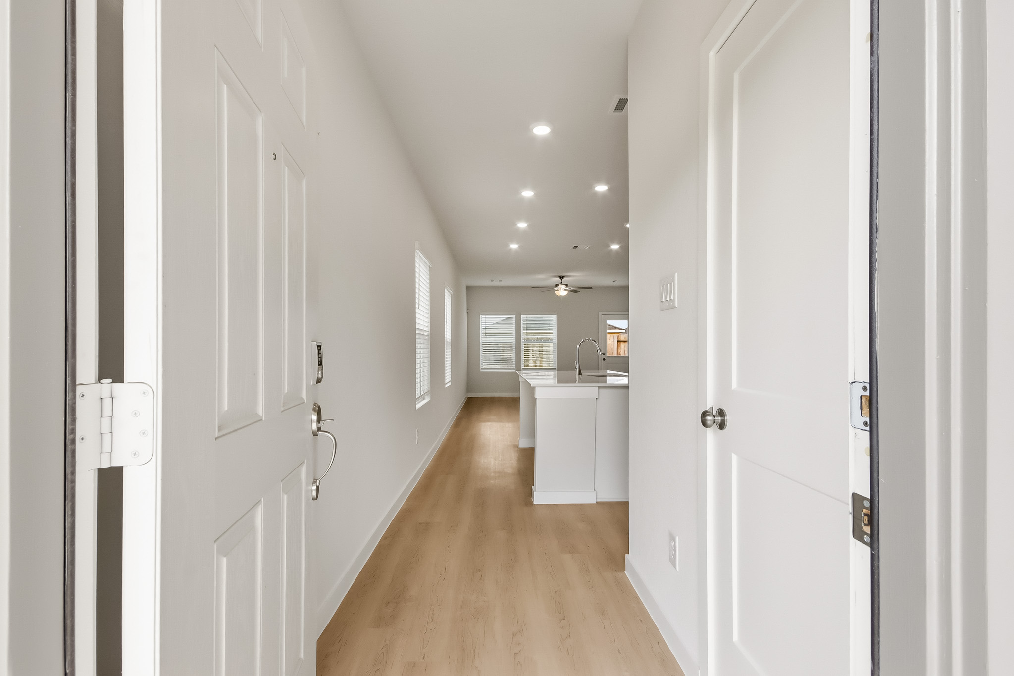 A hallway with white doors.