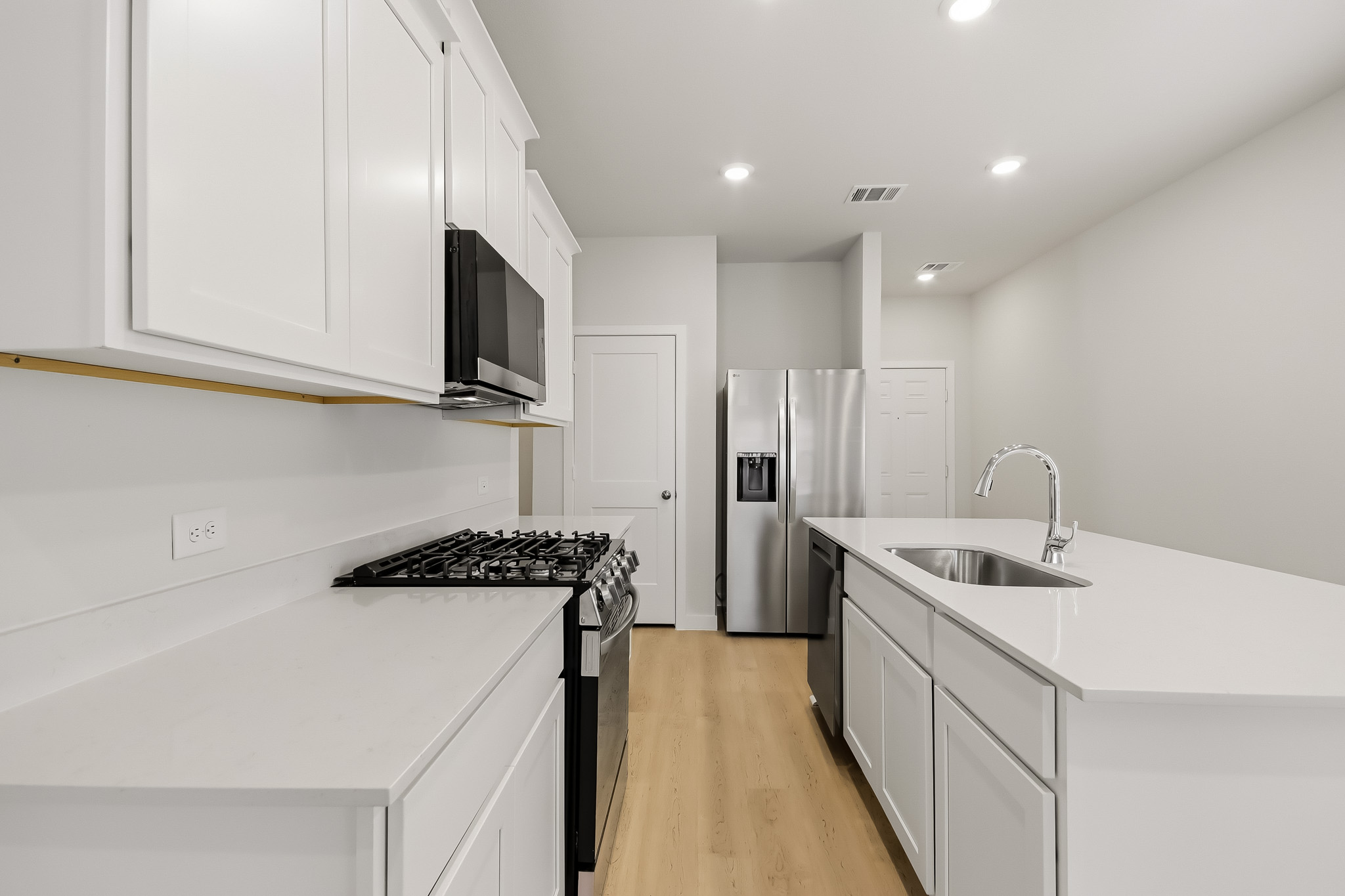 A kitchen with white cabinets.