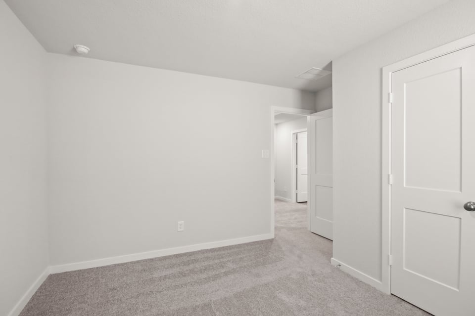 A hallway with white doors.