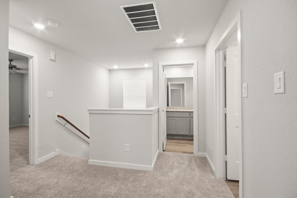 A room with a white wall and a white cabinet.