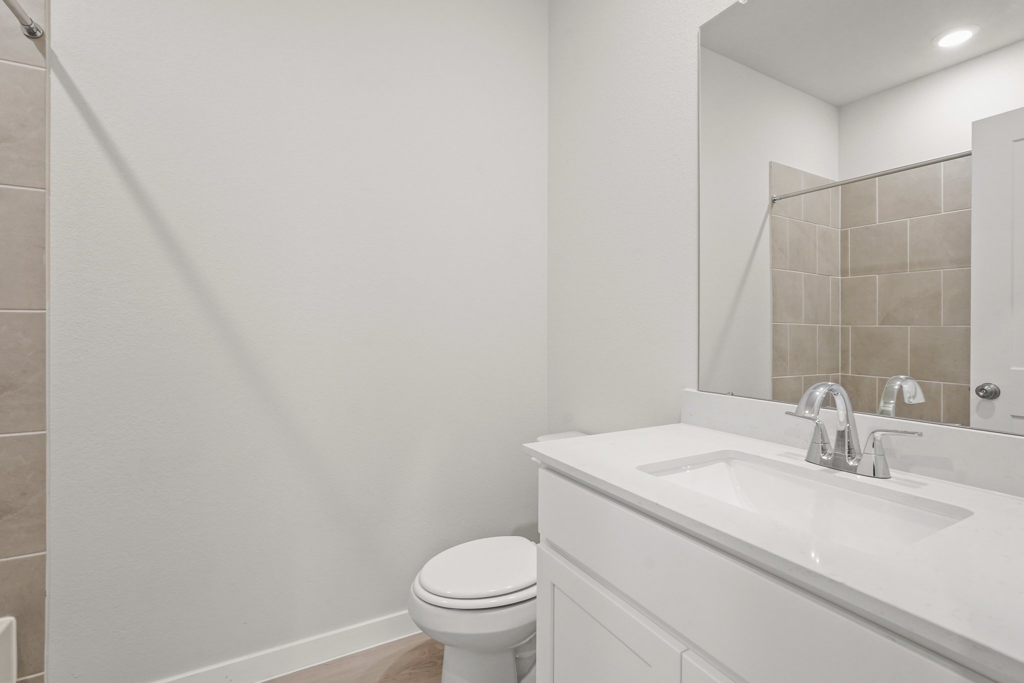 A bathroom with a sink and a toilet.
