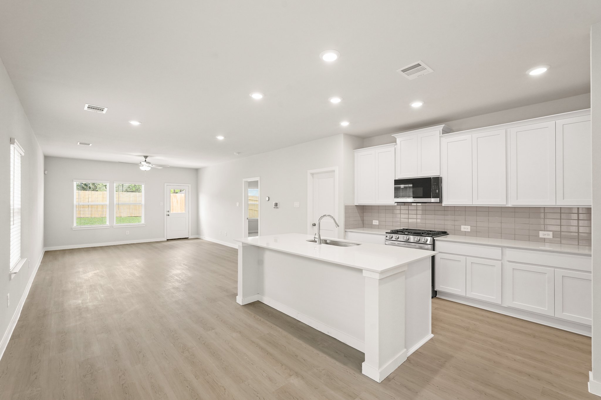 A kitchen with white cabinets.