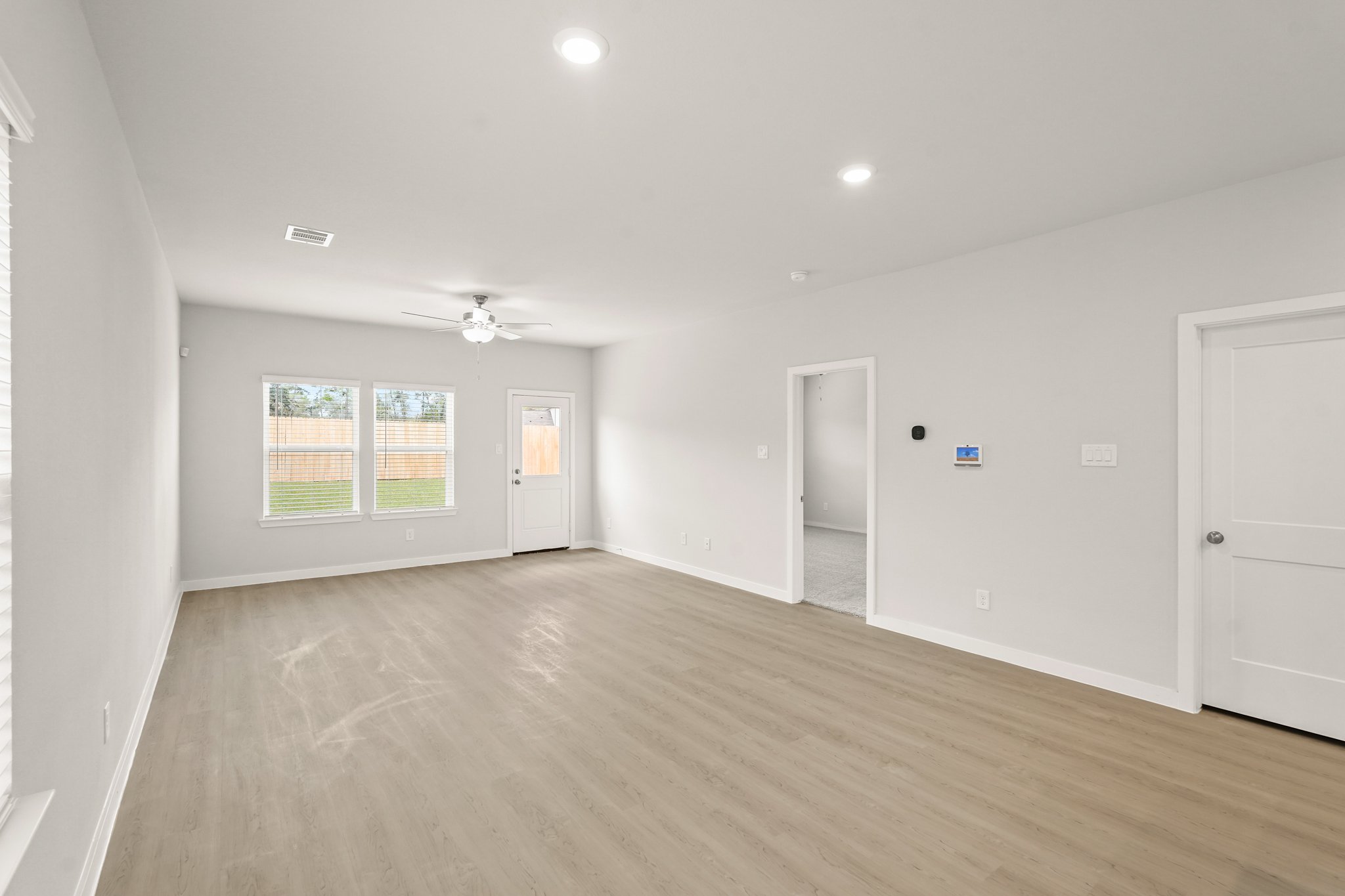 A room with a wood floor and white doors.