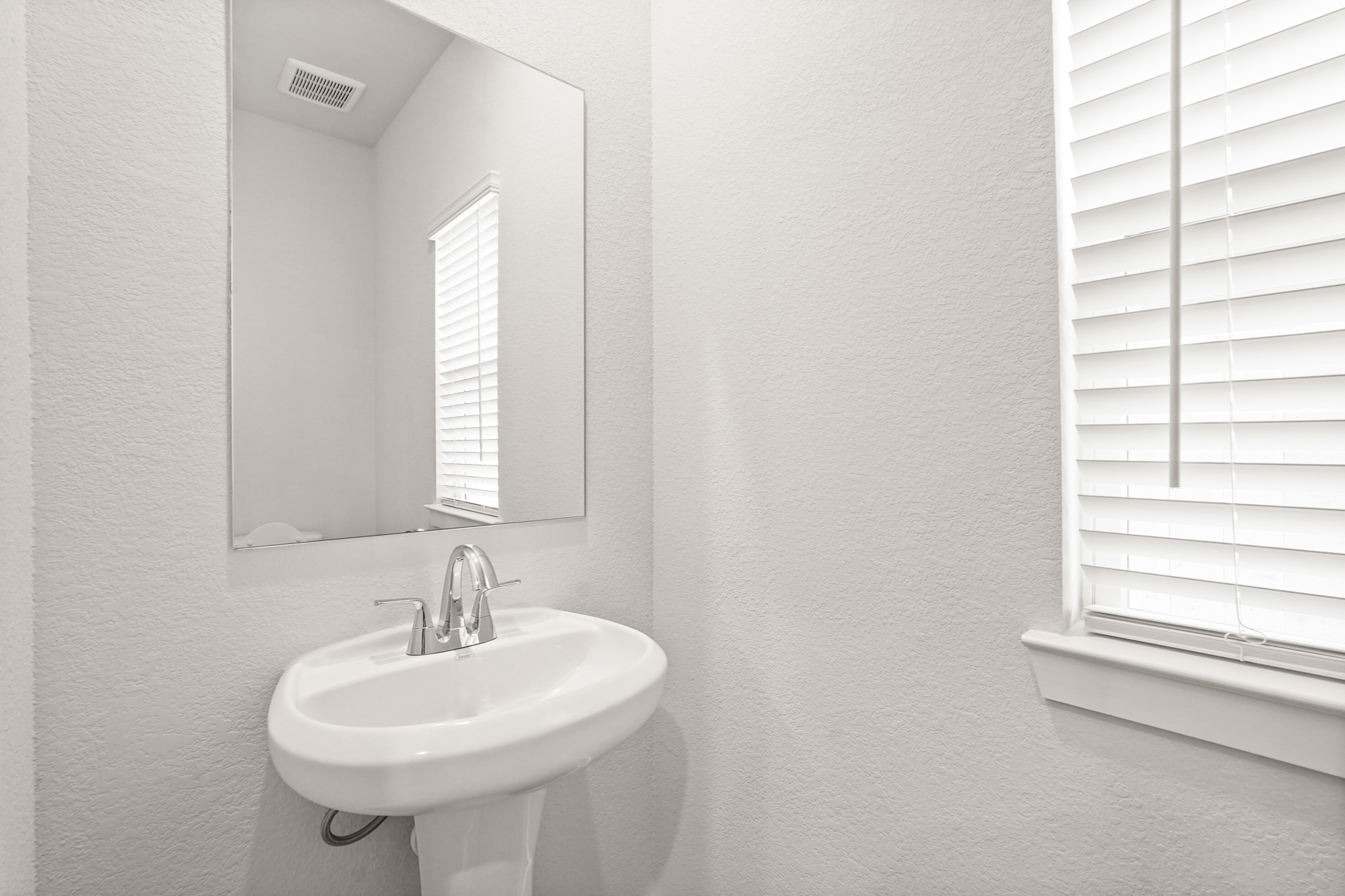 A bathroom with a sink and mirror.