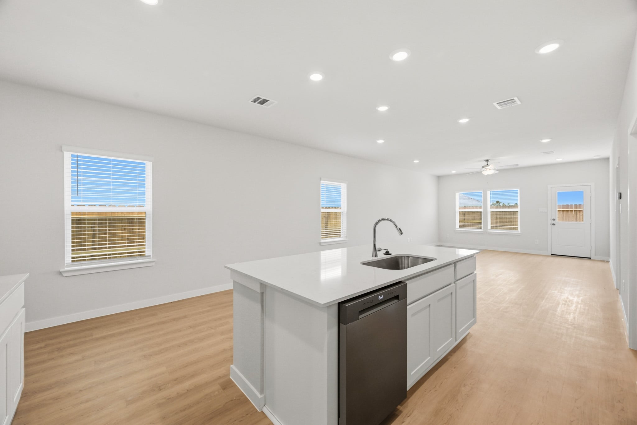 A kitchen with white cabinets.