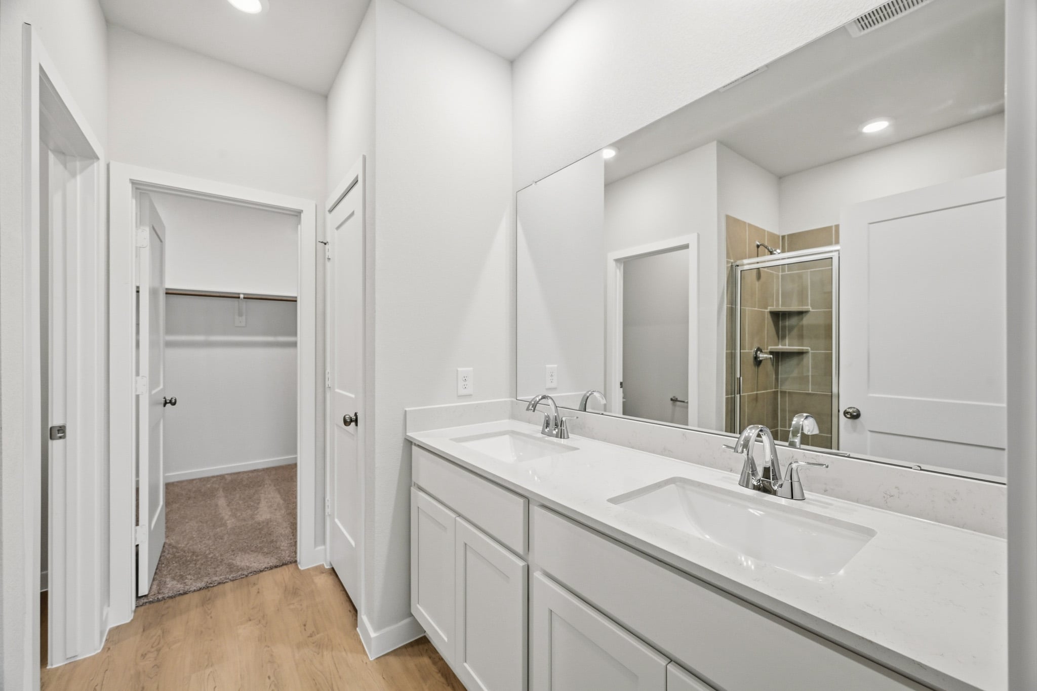 A bathroom with a large mirror.