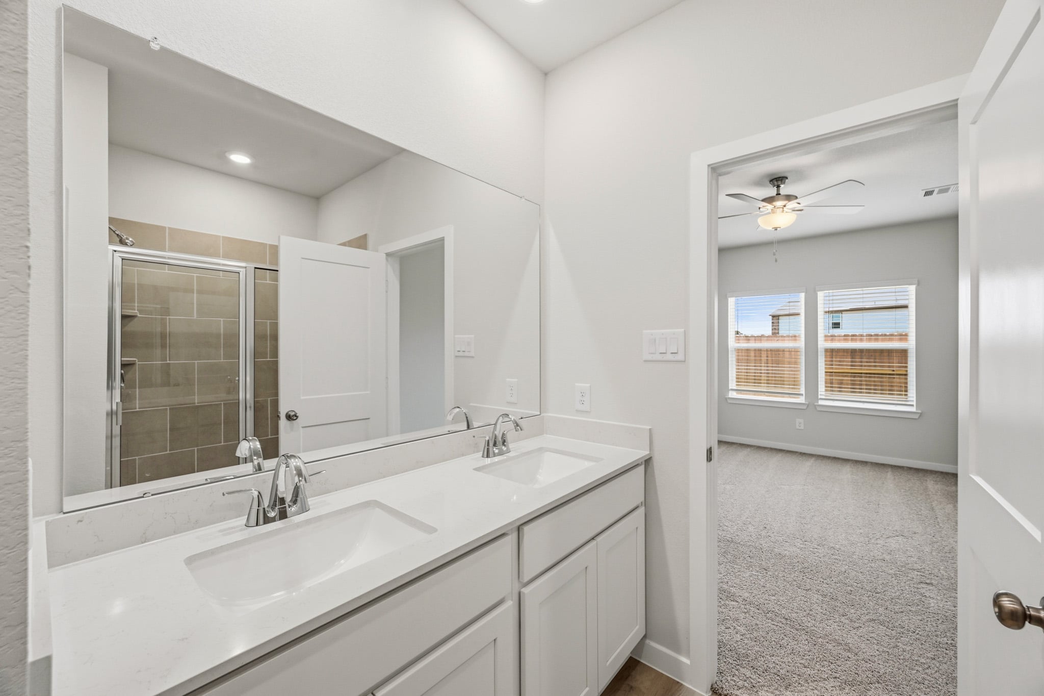 A bathroom with a large mirror.