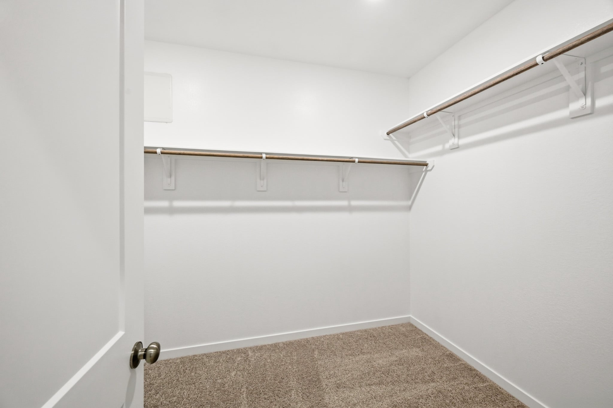 A white door with a metal bar.