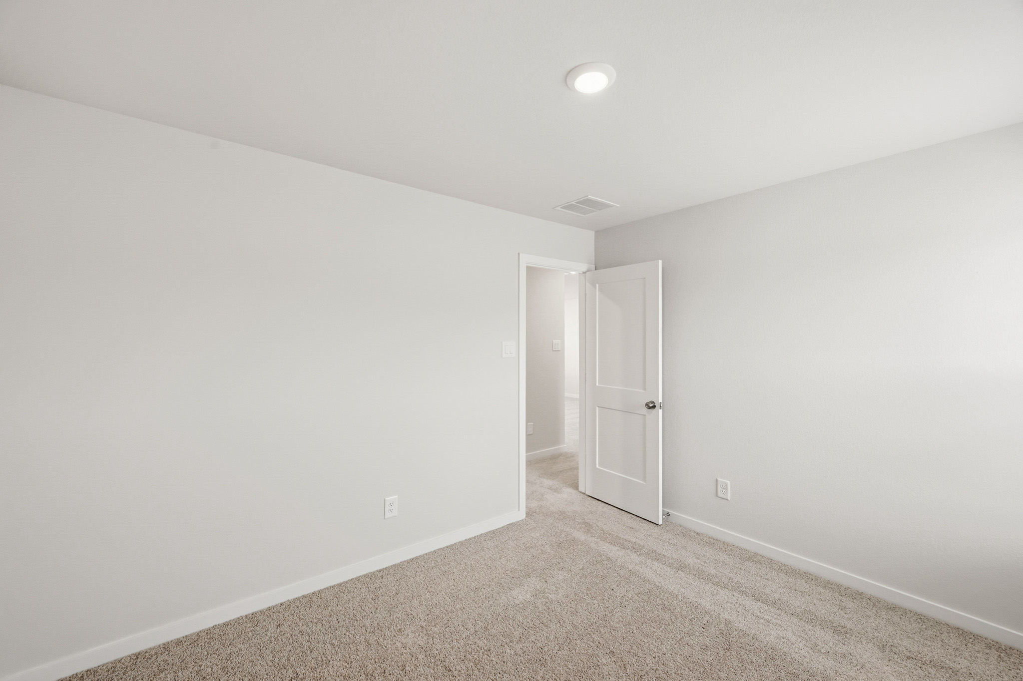 A hallway with white walls.