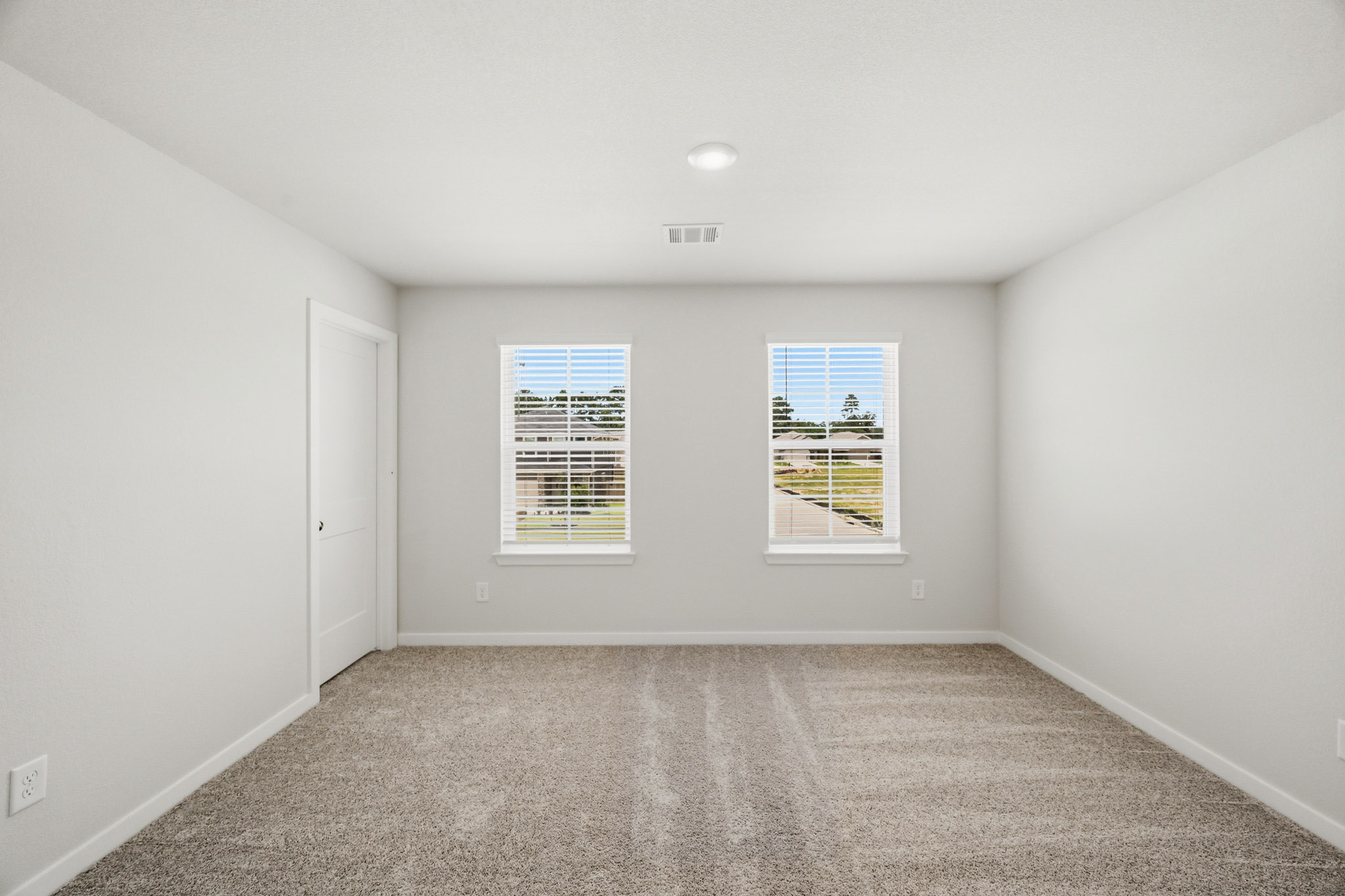 A room with white walls and a window.