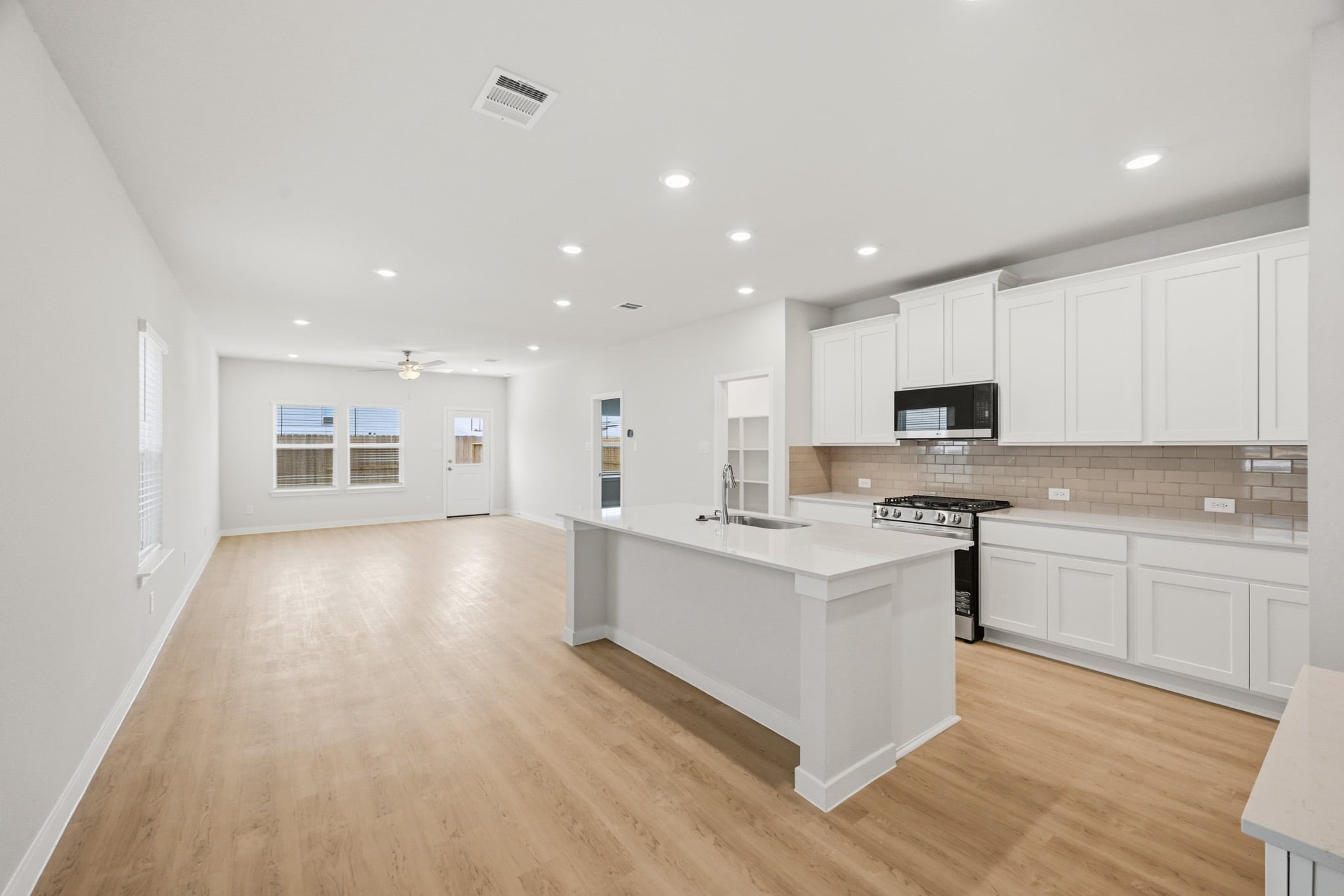 A kitchen with white cabinets.