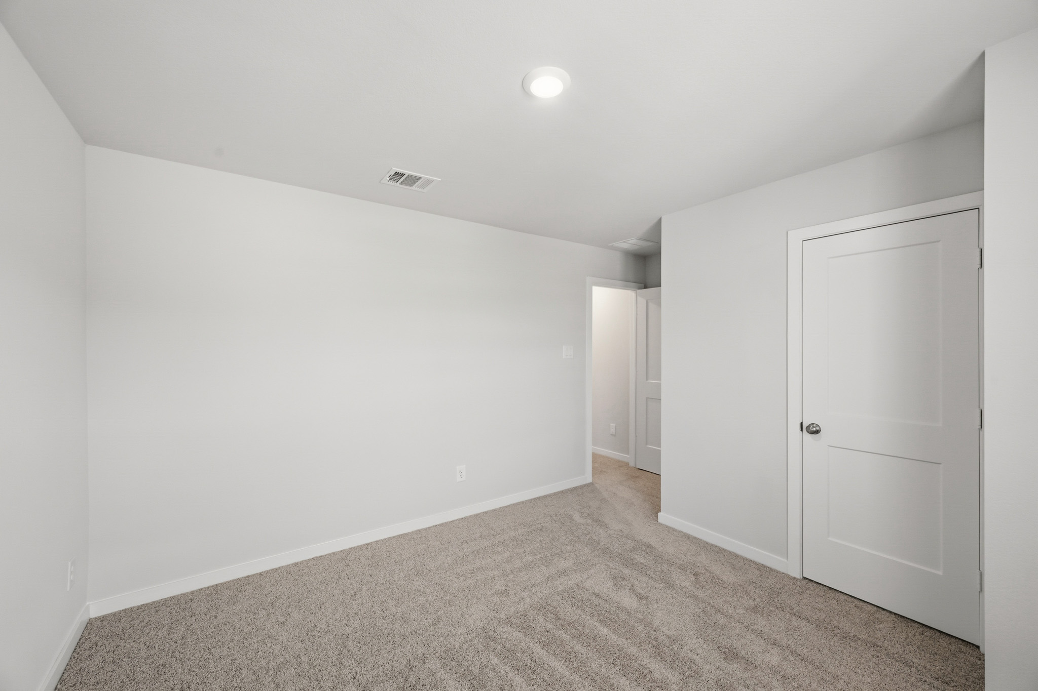 A hallway with white doors.
