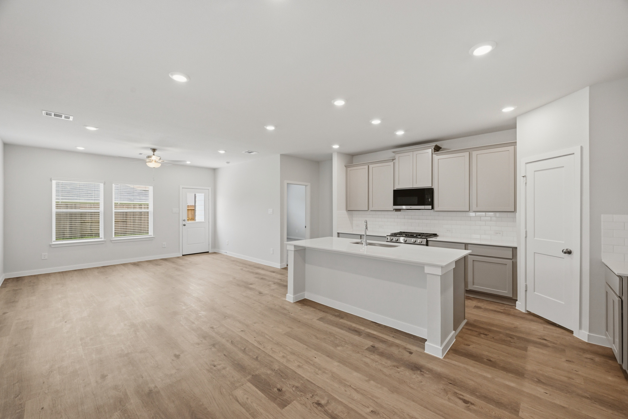 A kitchen with white cabinets.