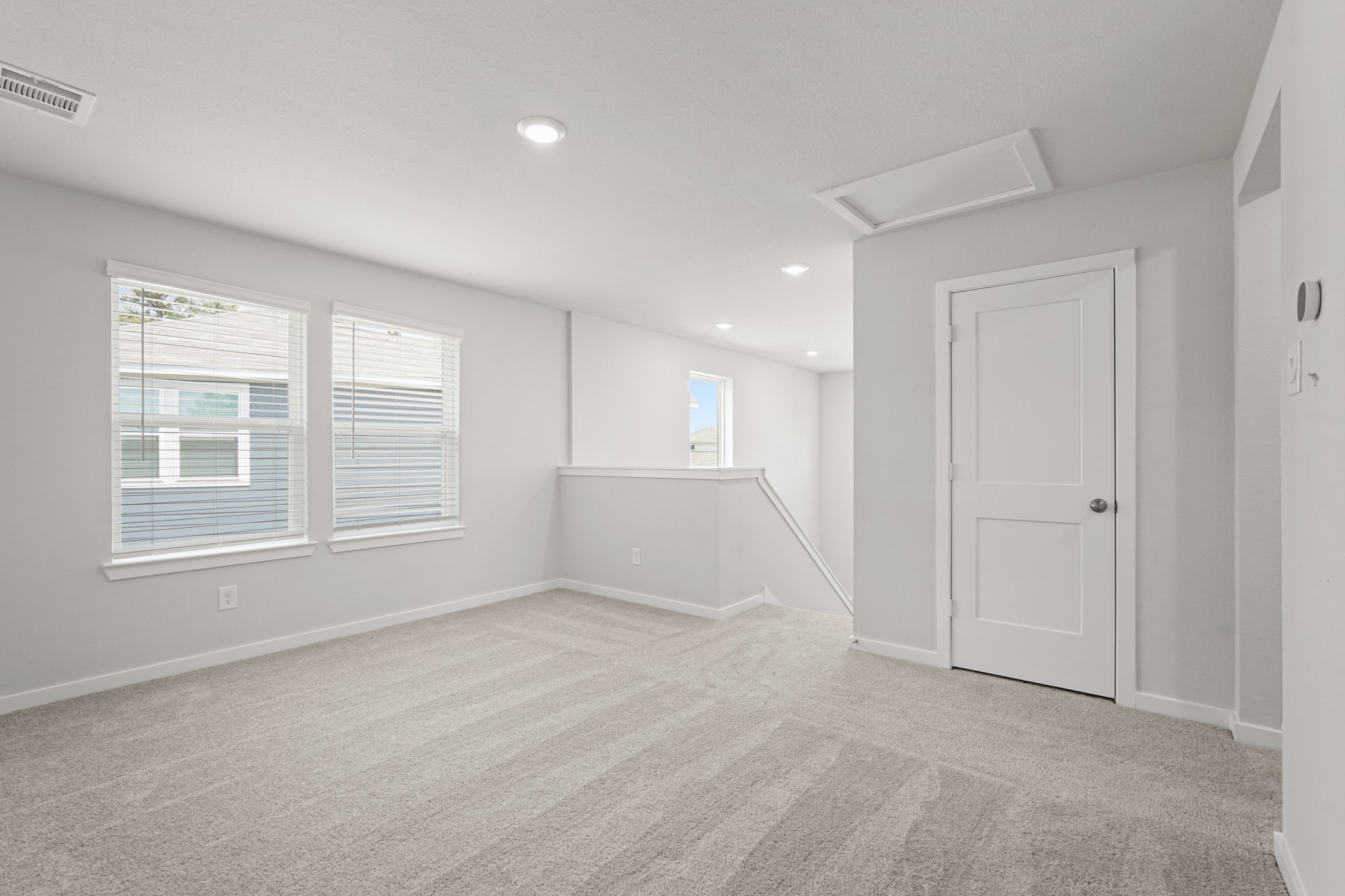 A room with white walls and a white door.