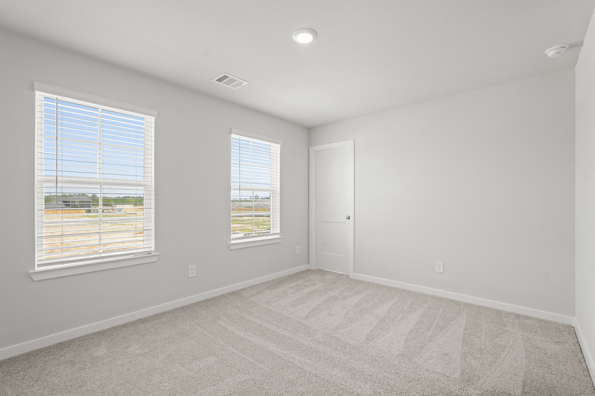 A room with windows and a door.