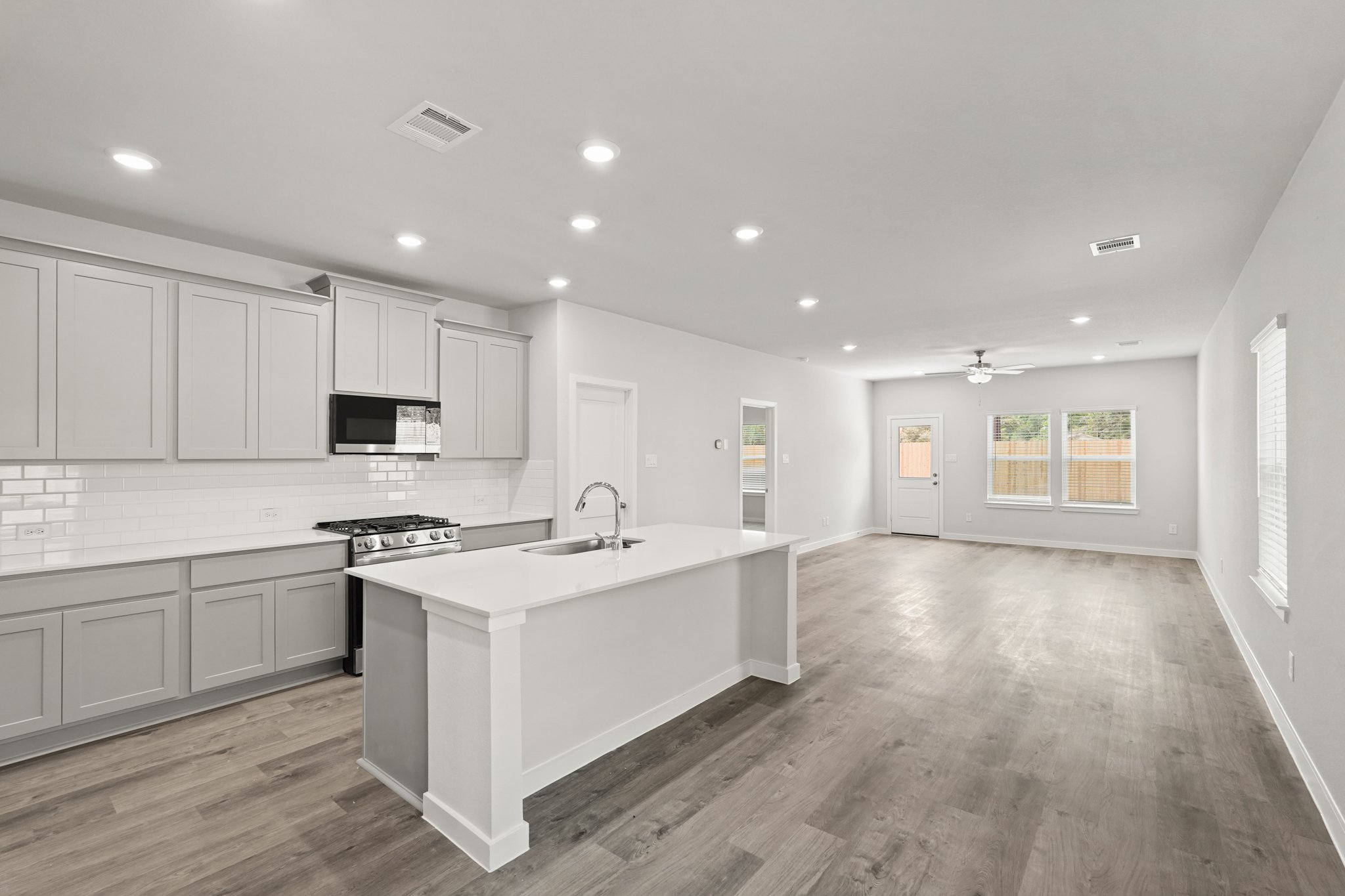 A kitchen with white cabinets.