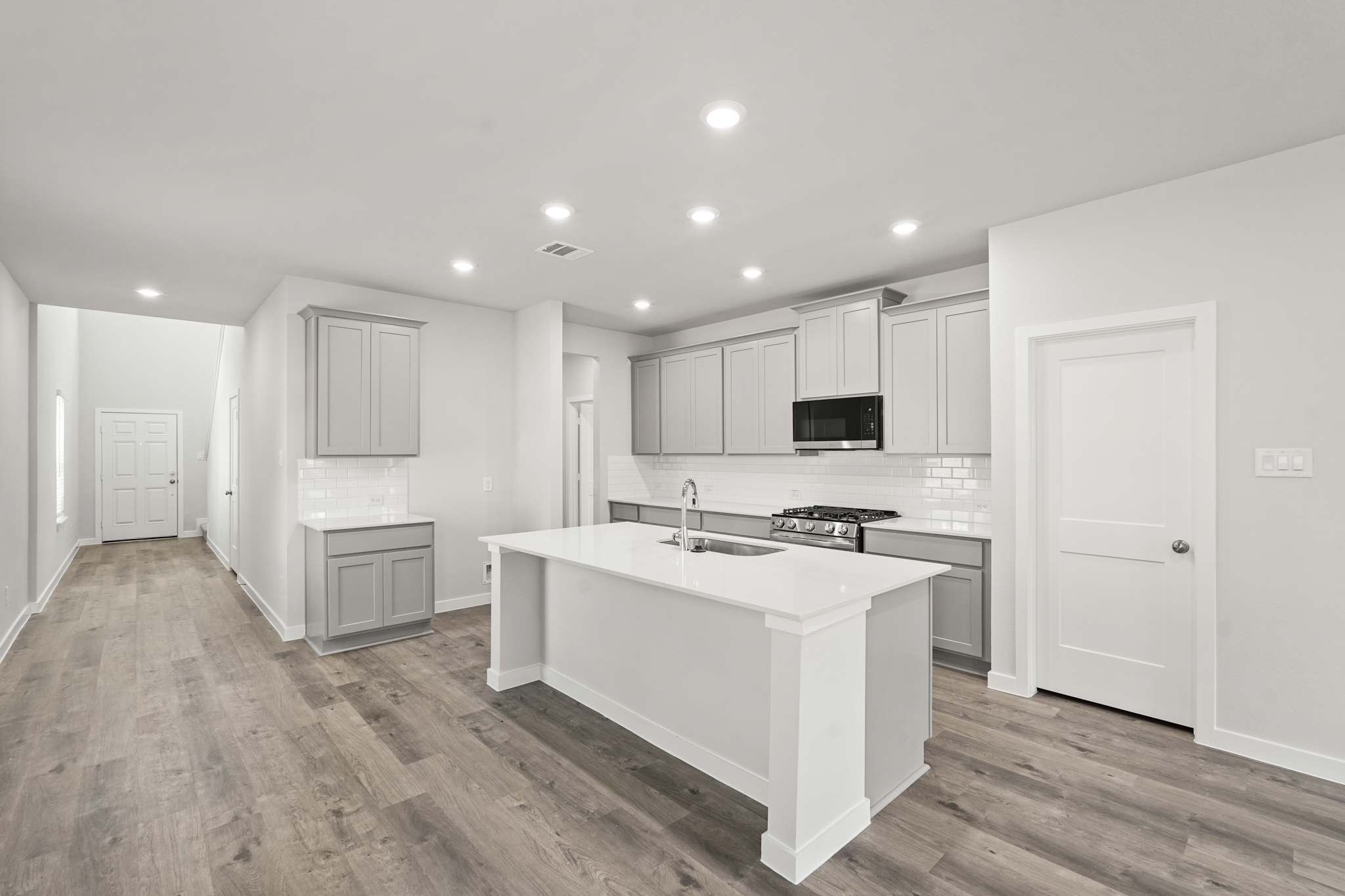 A kitchen with white cabinets.