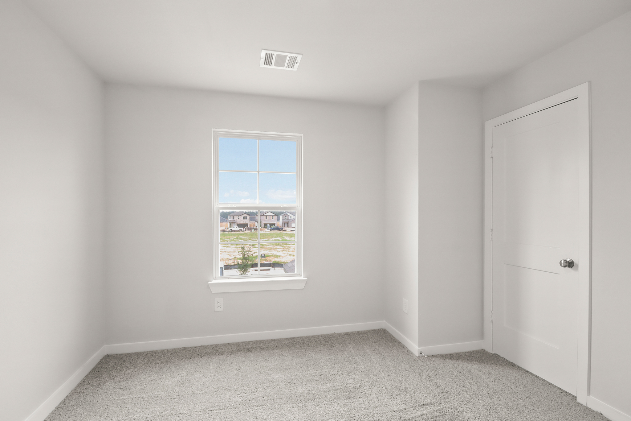 A room with a window and a door.