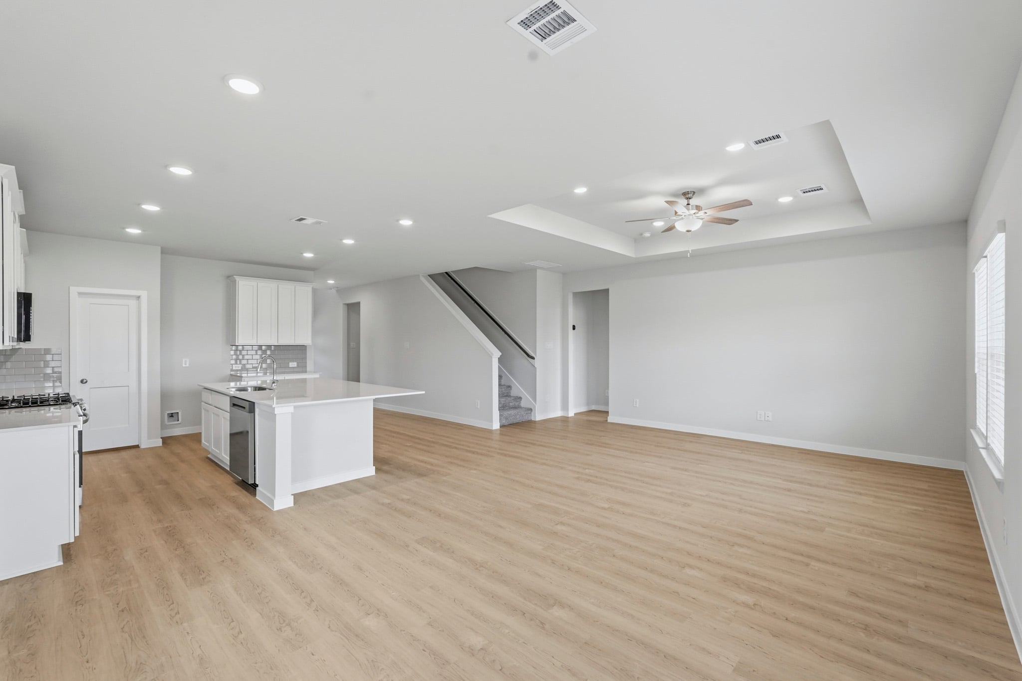 A large kitchen with white cabinets.