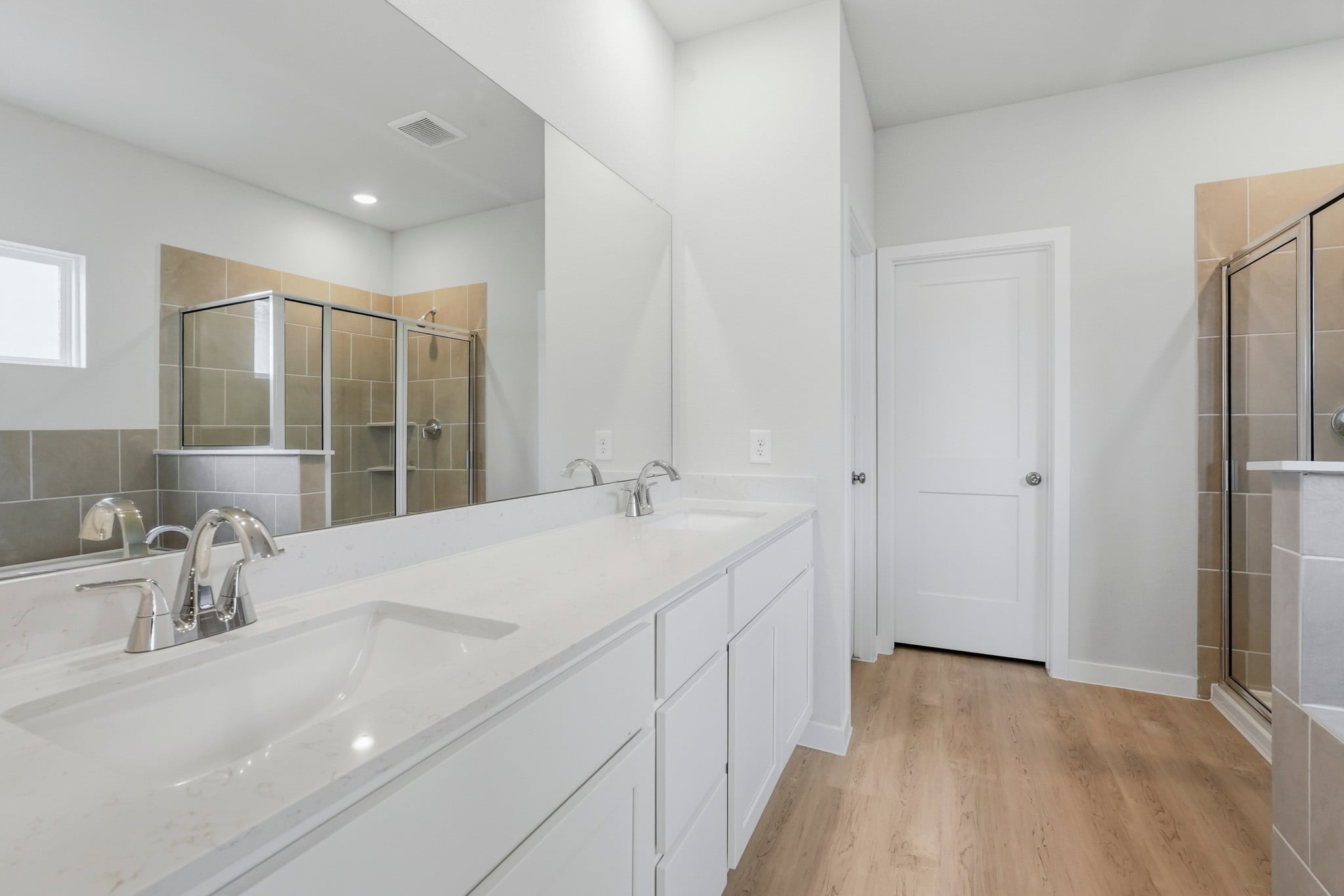 A bathroom with a large mirror.