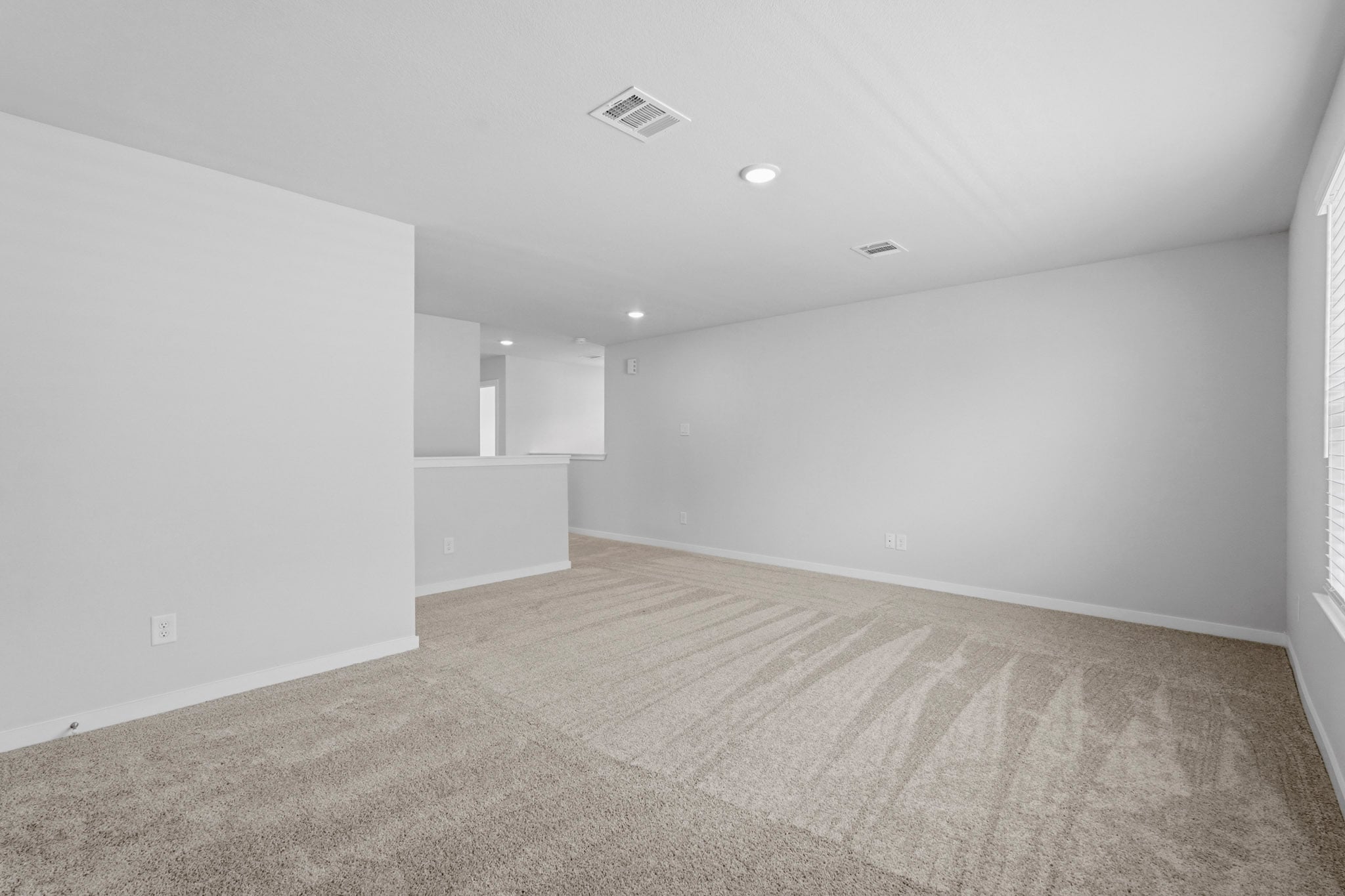 A long hallway with white walls.