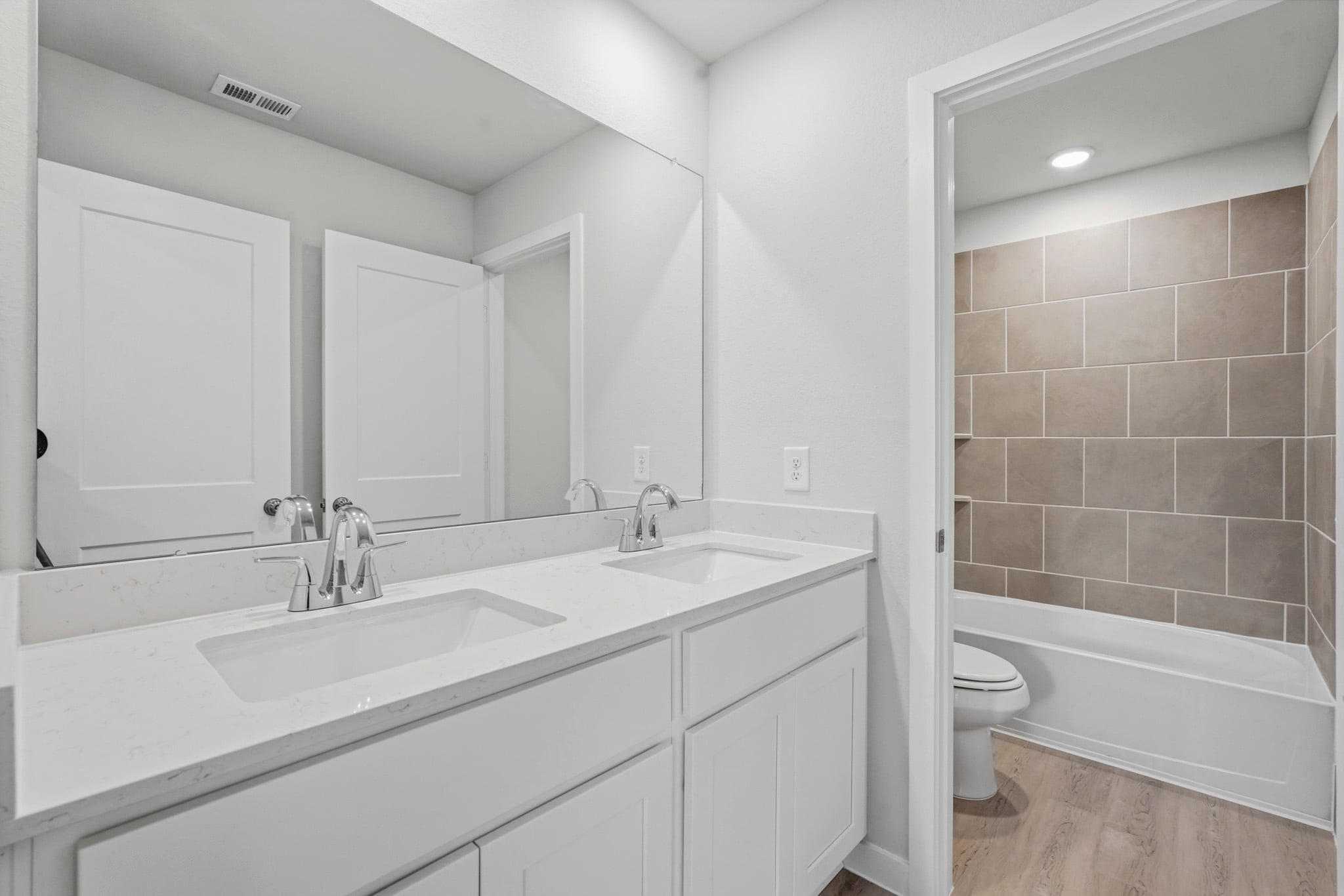 A bathroom with a tub sink and toilet.