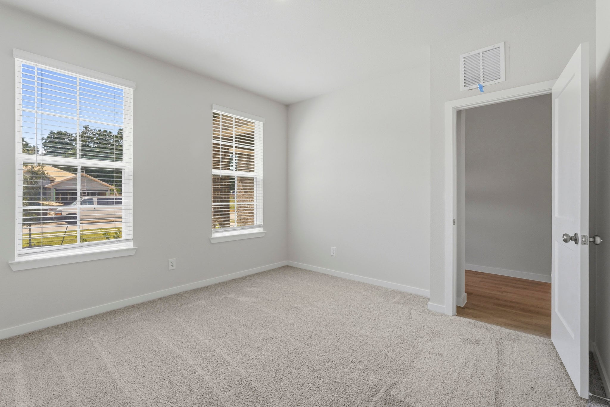 A room with a door and windows.