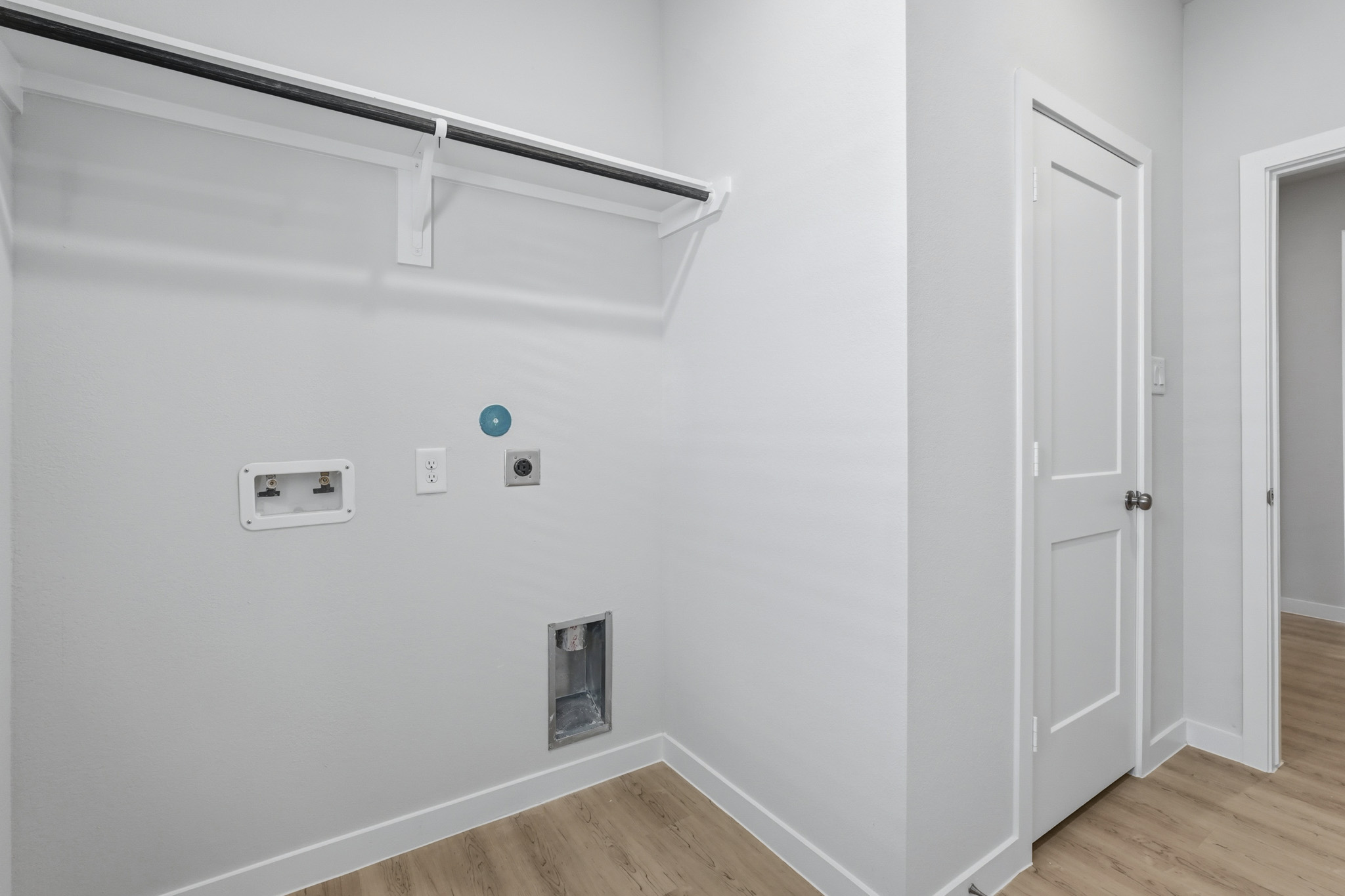 A white wall with a white door.