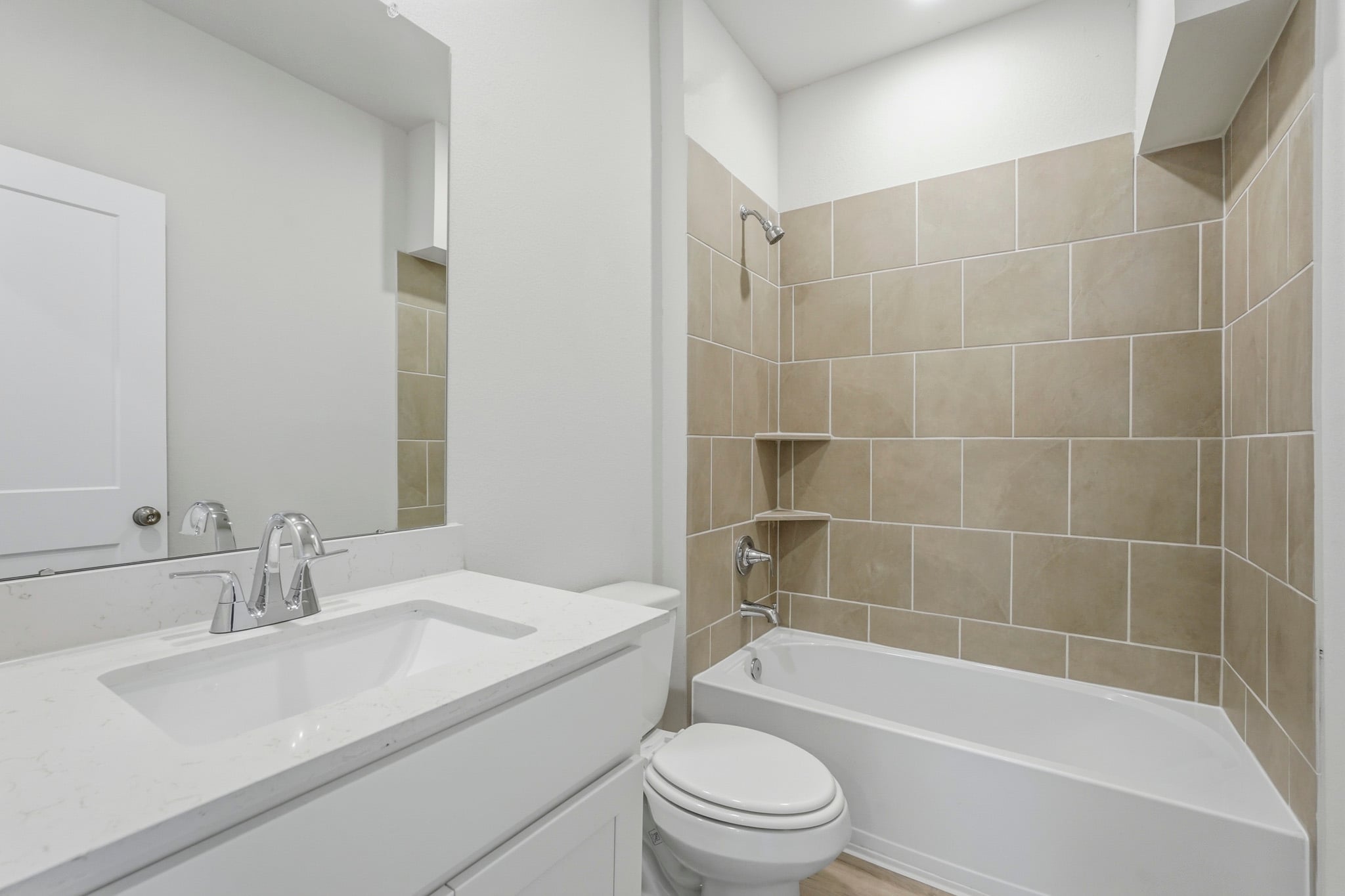 A bathroom with a tub sink and toilet.