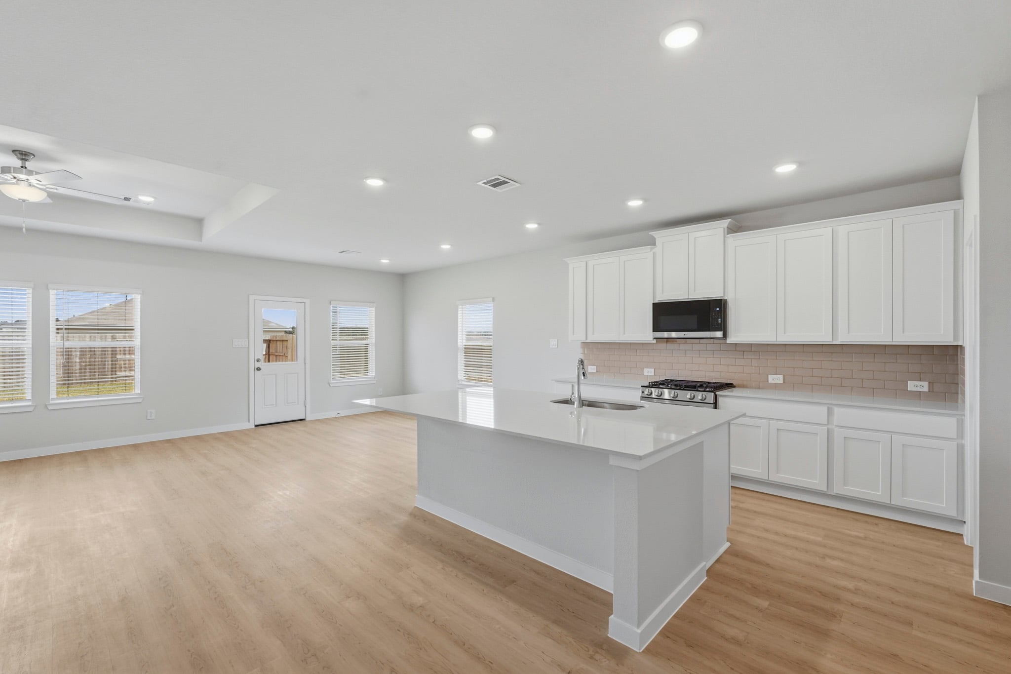 A kitchen with white cabinets.